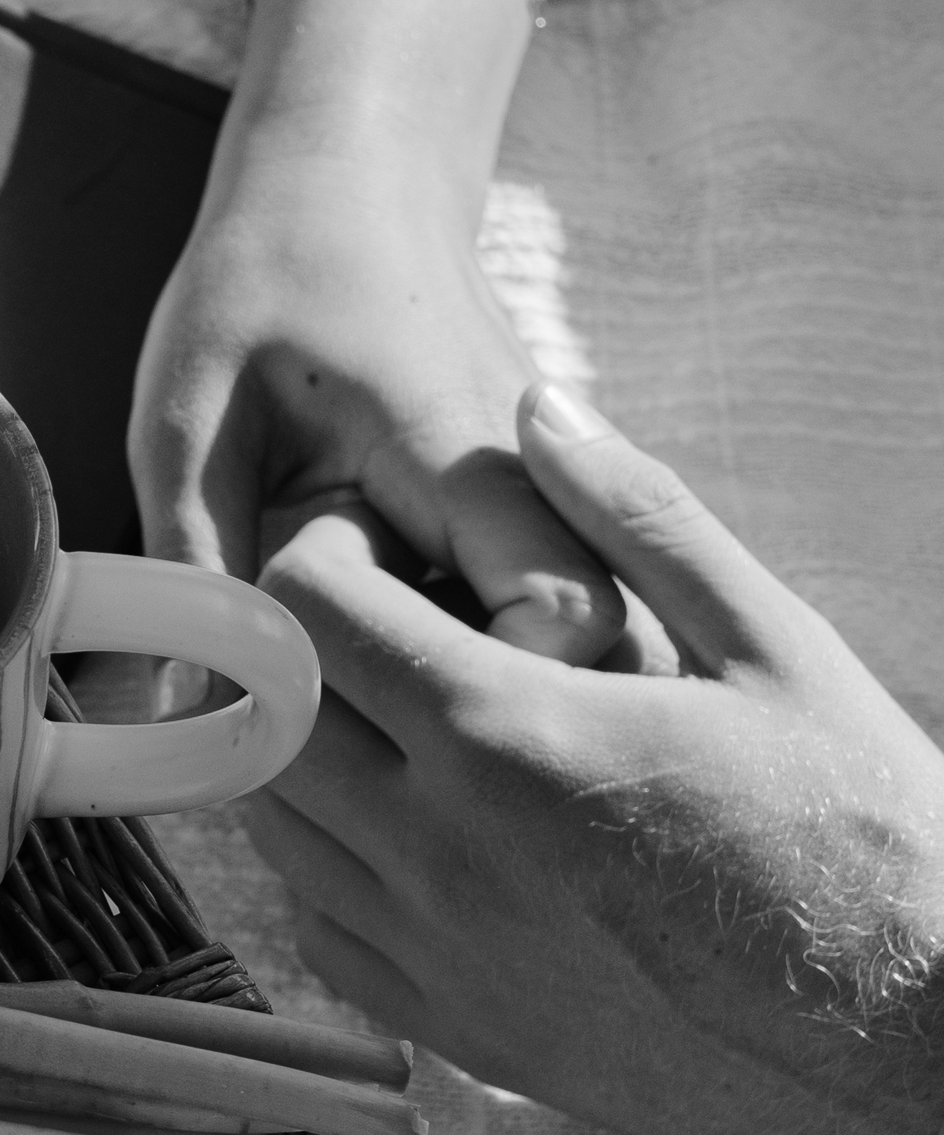 A couple holding hands during their beach engagement pictures