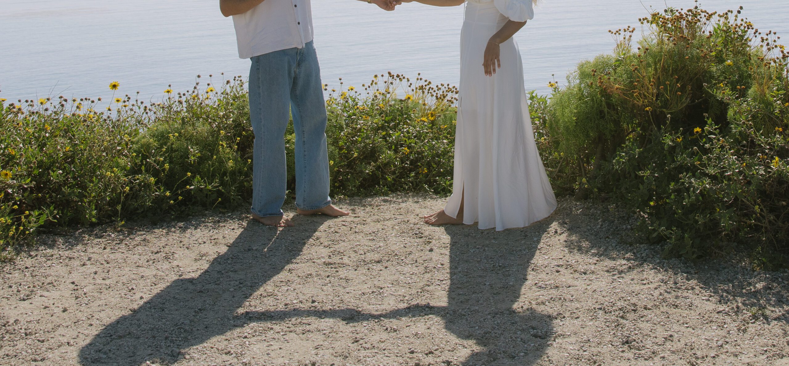 A couple holding hands during Malibu Beach photos