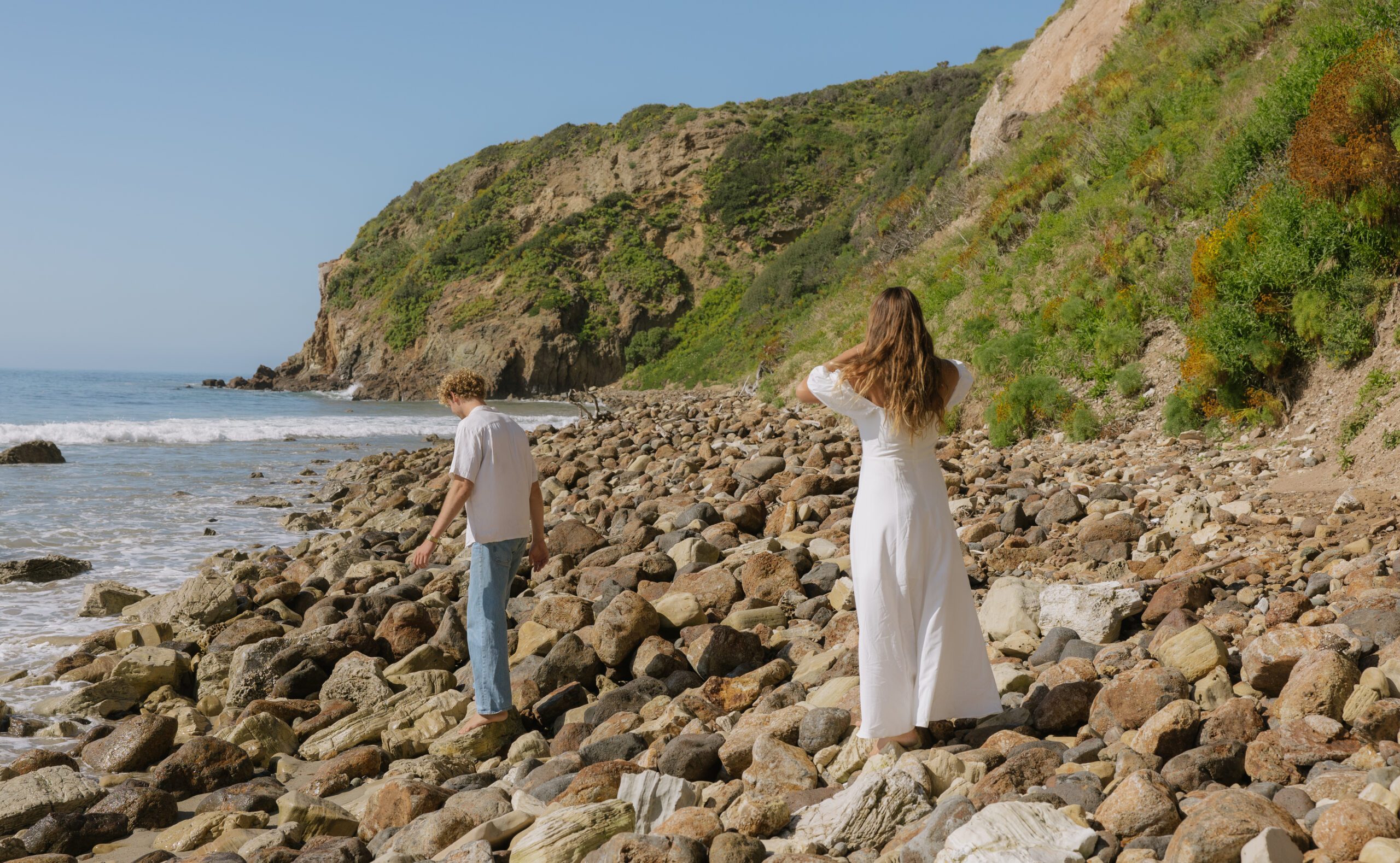 A couple standing on the rocks at Malibu Beach