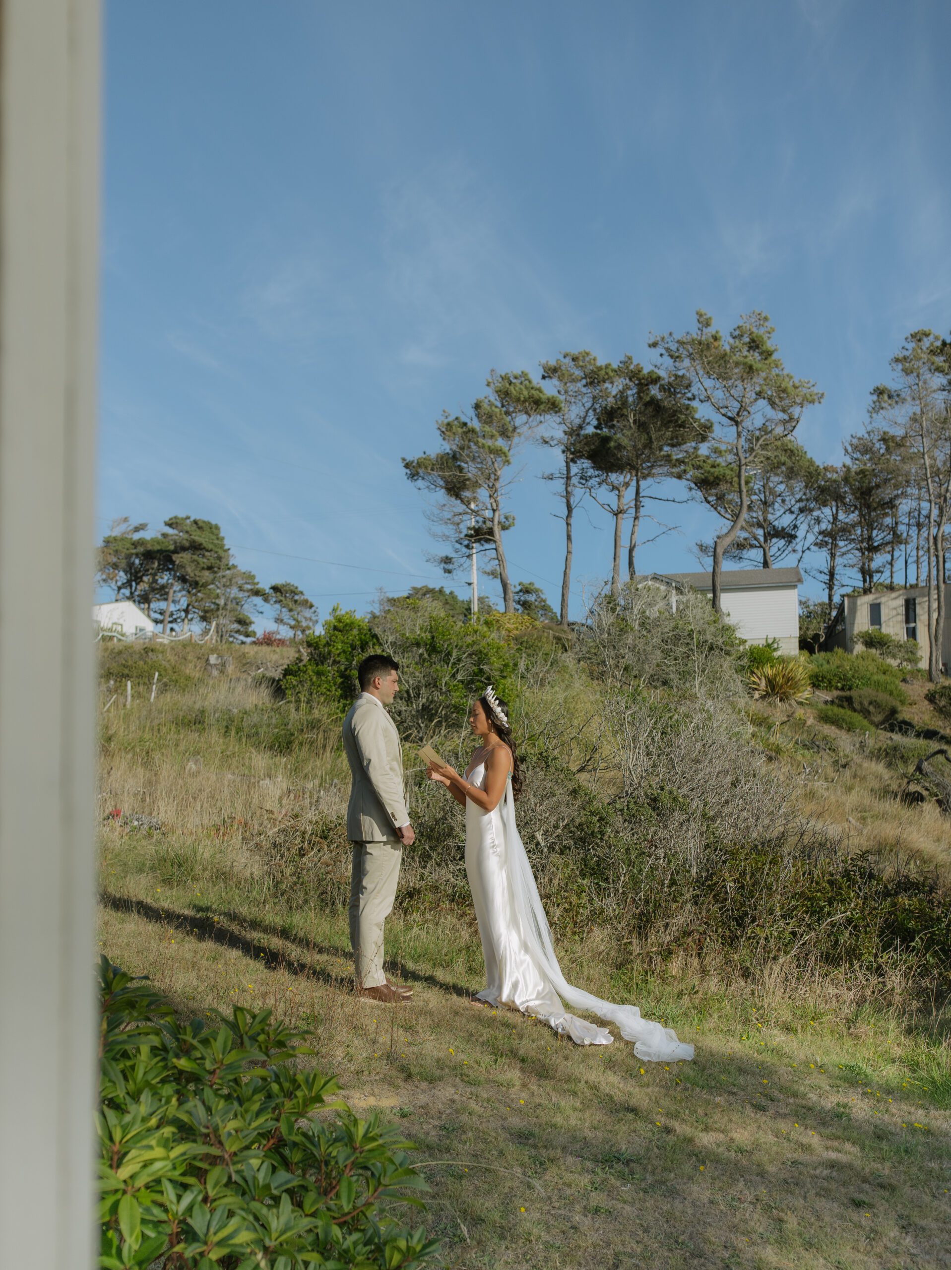 A bride and groom reading private vows during their Bodega Bay wedding