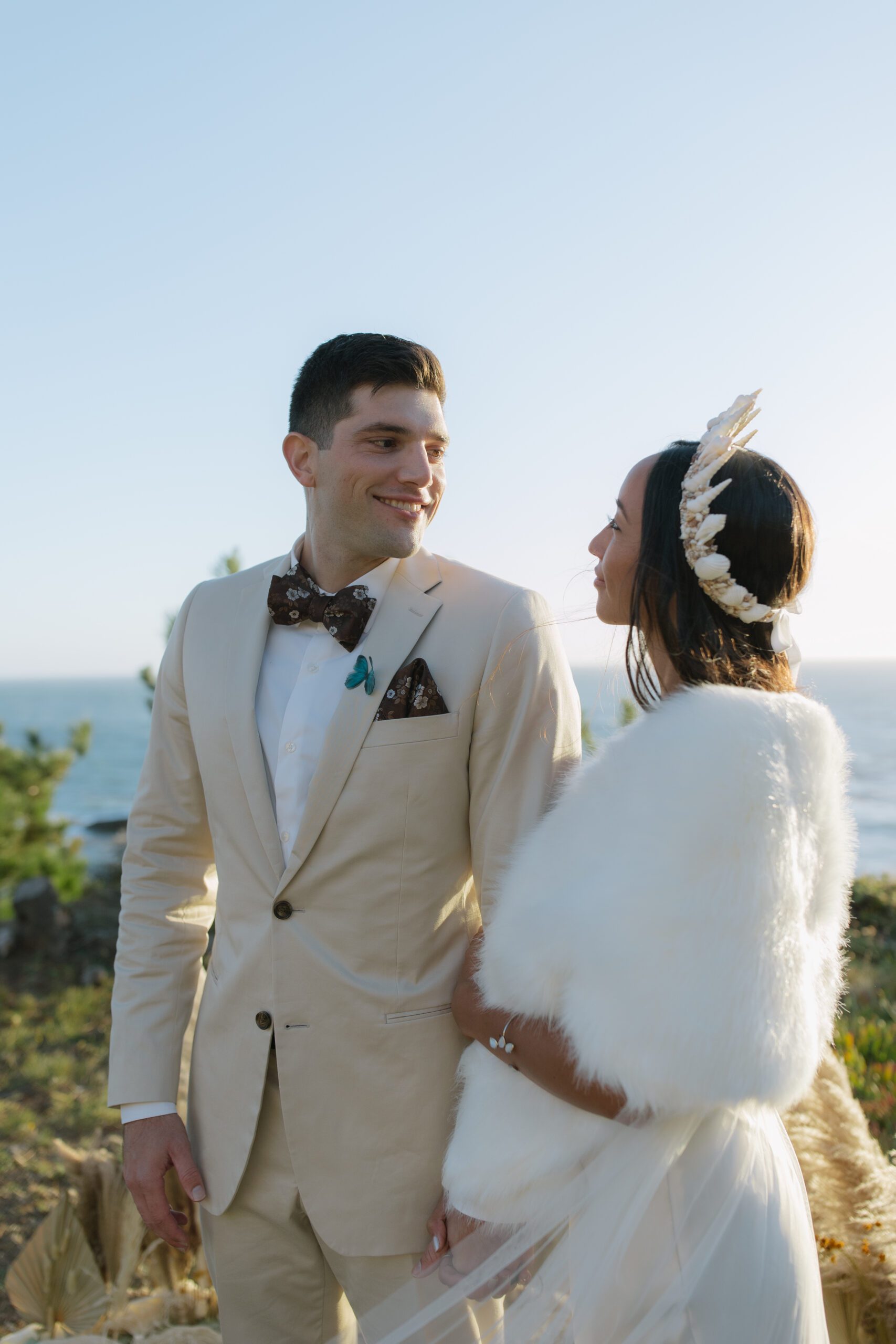 A bride and groom posing for waterfront wedding photos