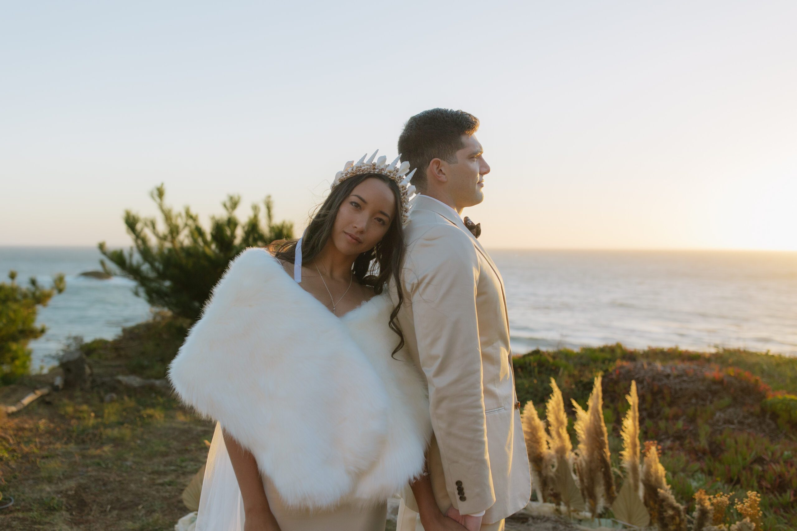 A bride and groom posing for waterfront wedding photos