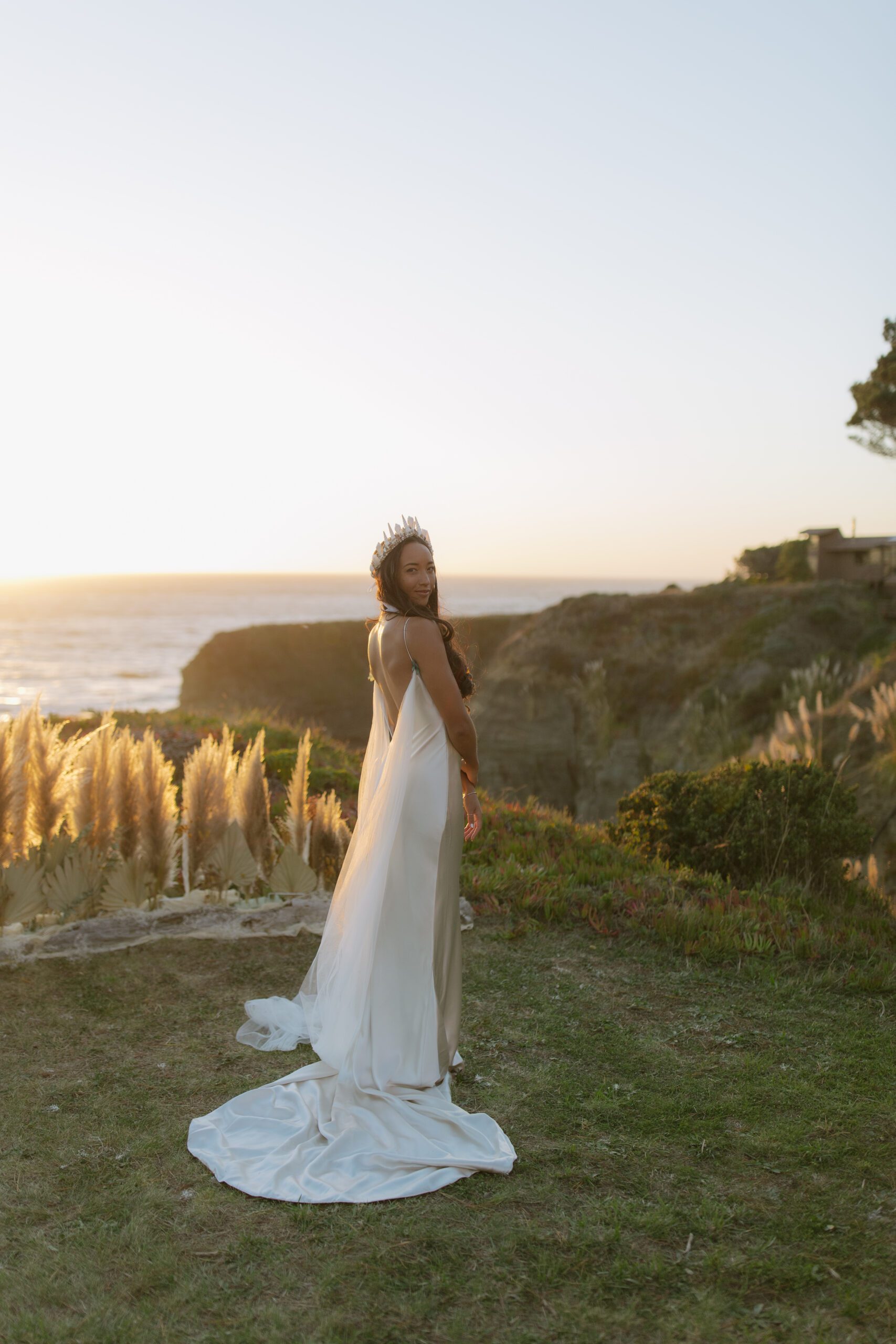 A bride wearing a satin dress for a coastal california wedding