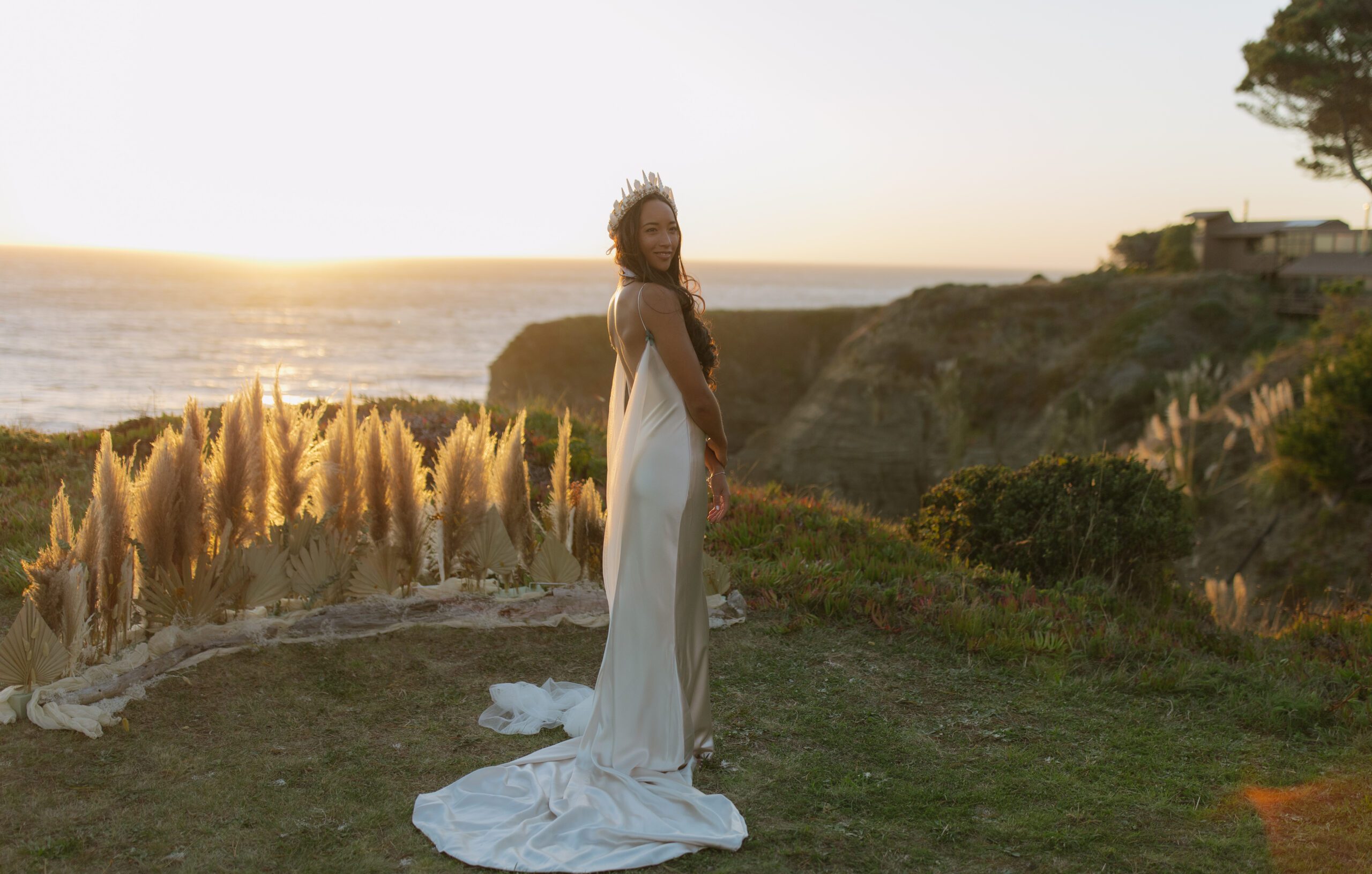 A bride posing for bridal portraits in a waterfront wedding location