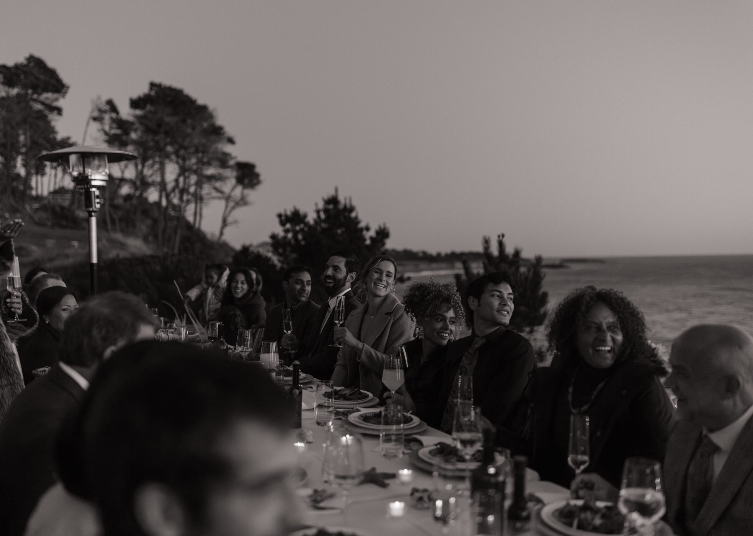 A candid photo from an outdoor watefront wedding reception