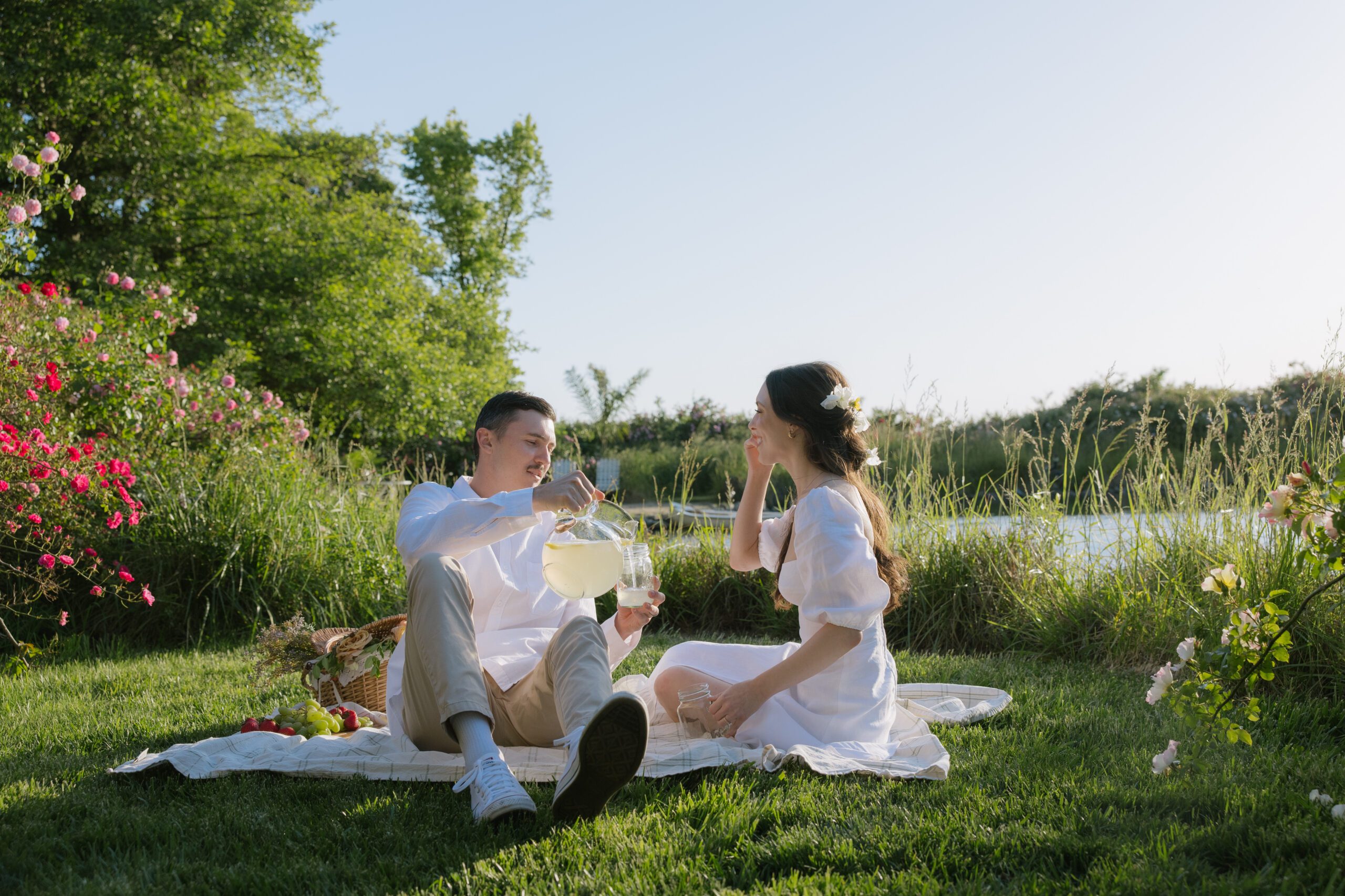 A man pouring lemonade for his fiancee at their engagement photo location, Cavaignac