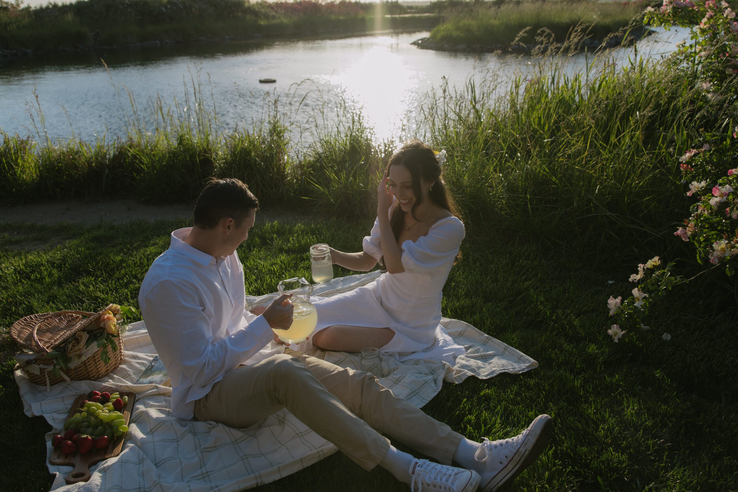 A couple drinking lemonade at their engagement photoshoot