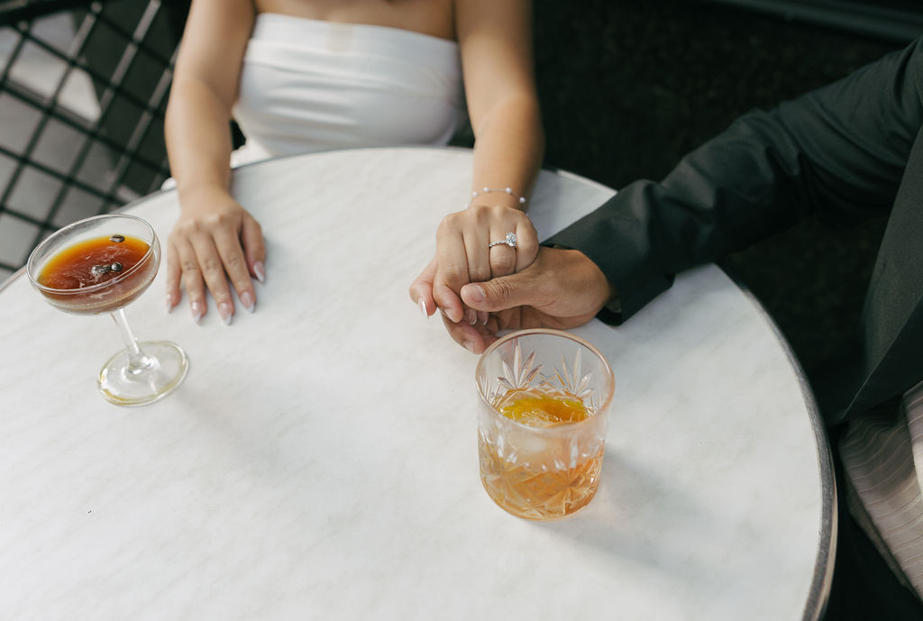 A couple having cocktails at their bar engagement photos