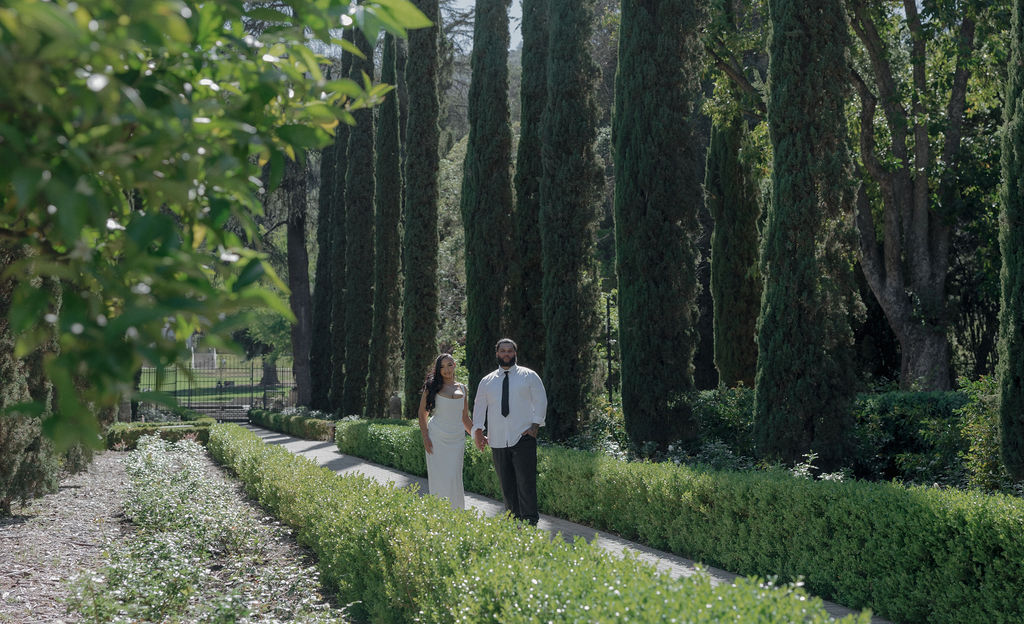 A wedding couple taking photos on the path at Montalvo Arts Center