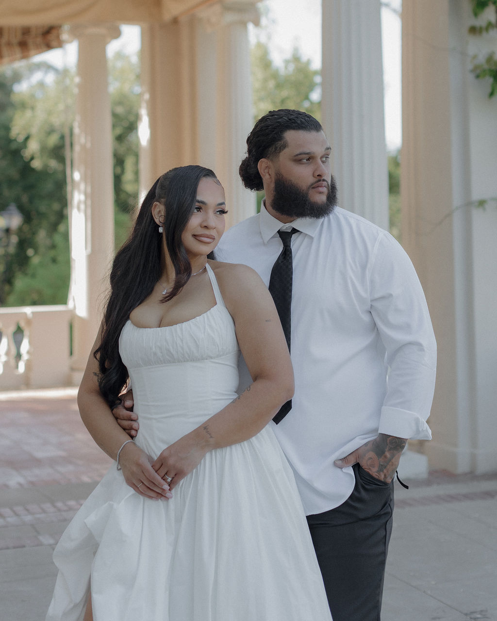 A bride and groom posing for wedding photos at Montalvo Arts Center on the courtyard