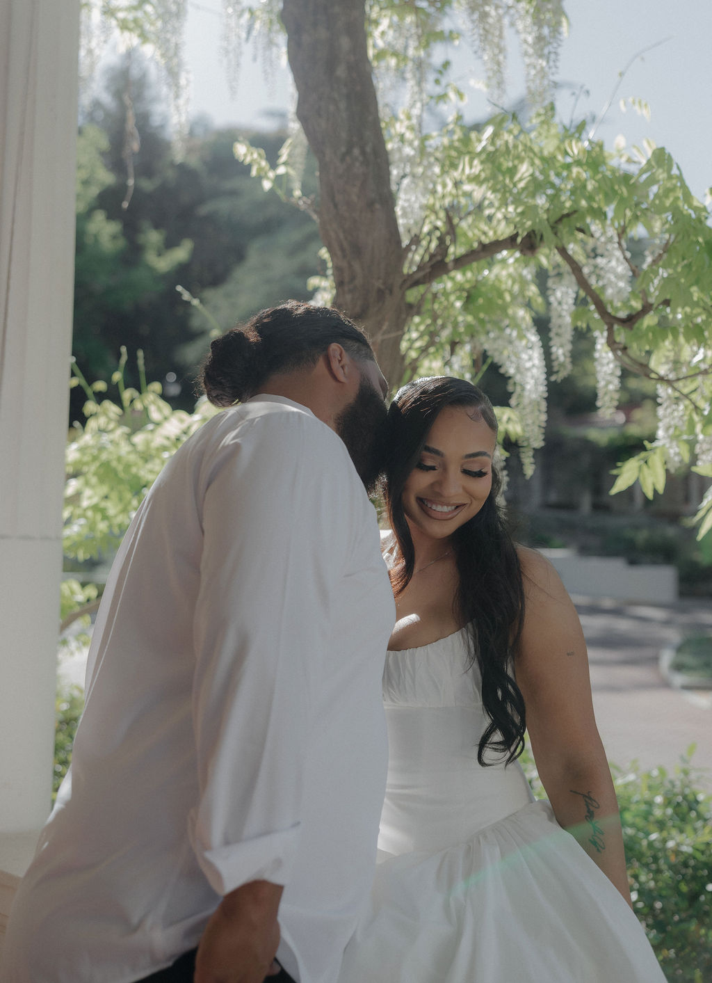 A groom kissing a bride for wedding photos