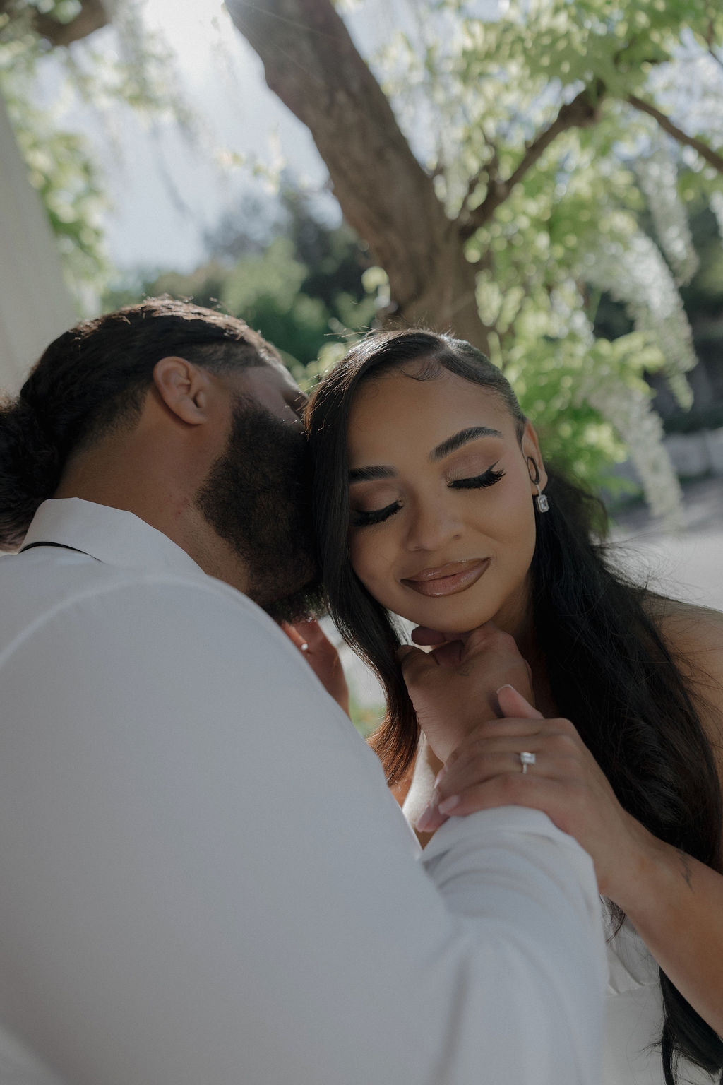 A groom kissing a bride for wedding photos