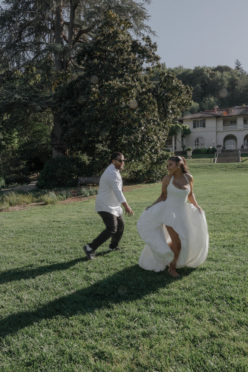 A couple running on the lawn at their Montalvo Arts Center wedding