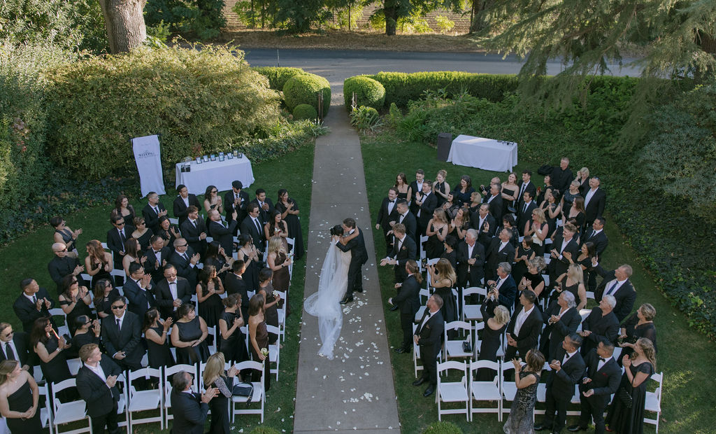 A couple kissing after exiting their wedding ceremony