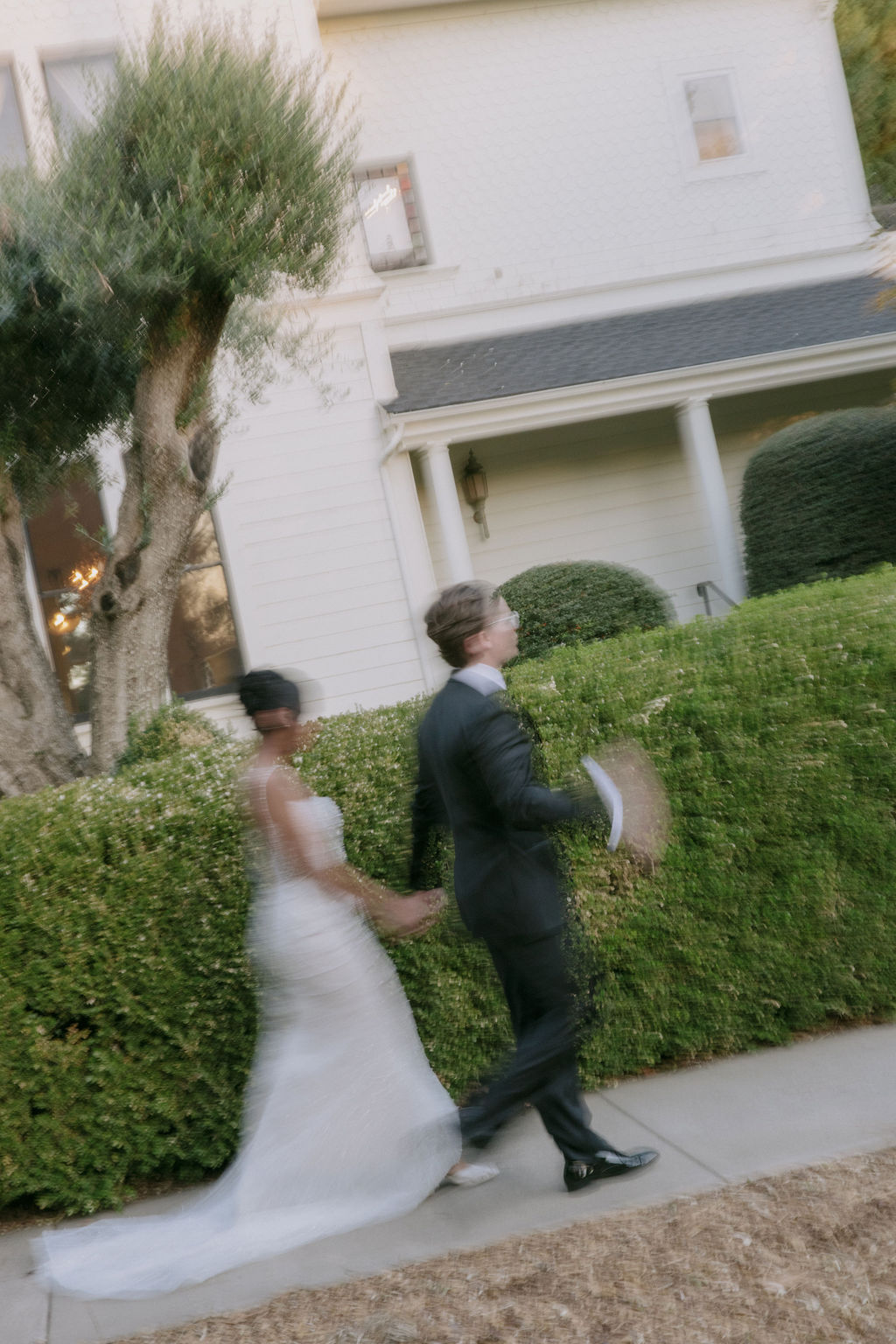 A blurry photo of a bride and groom walking it