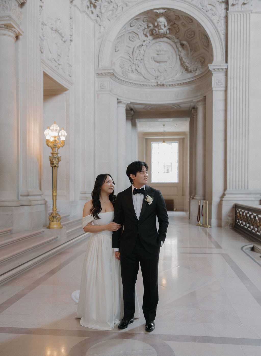 A bride and groom inside of San Francisco city hall 