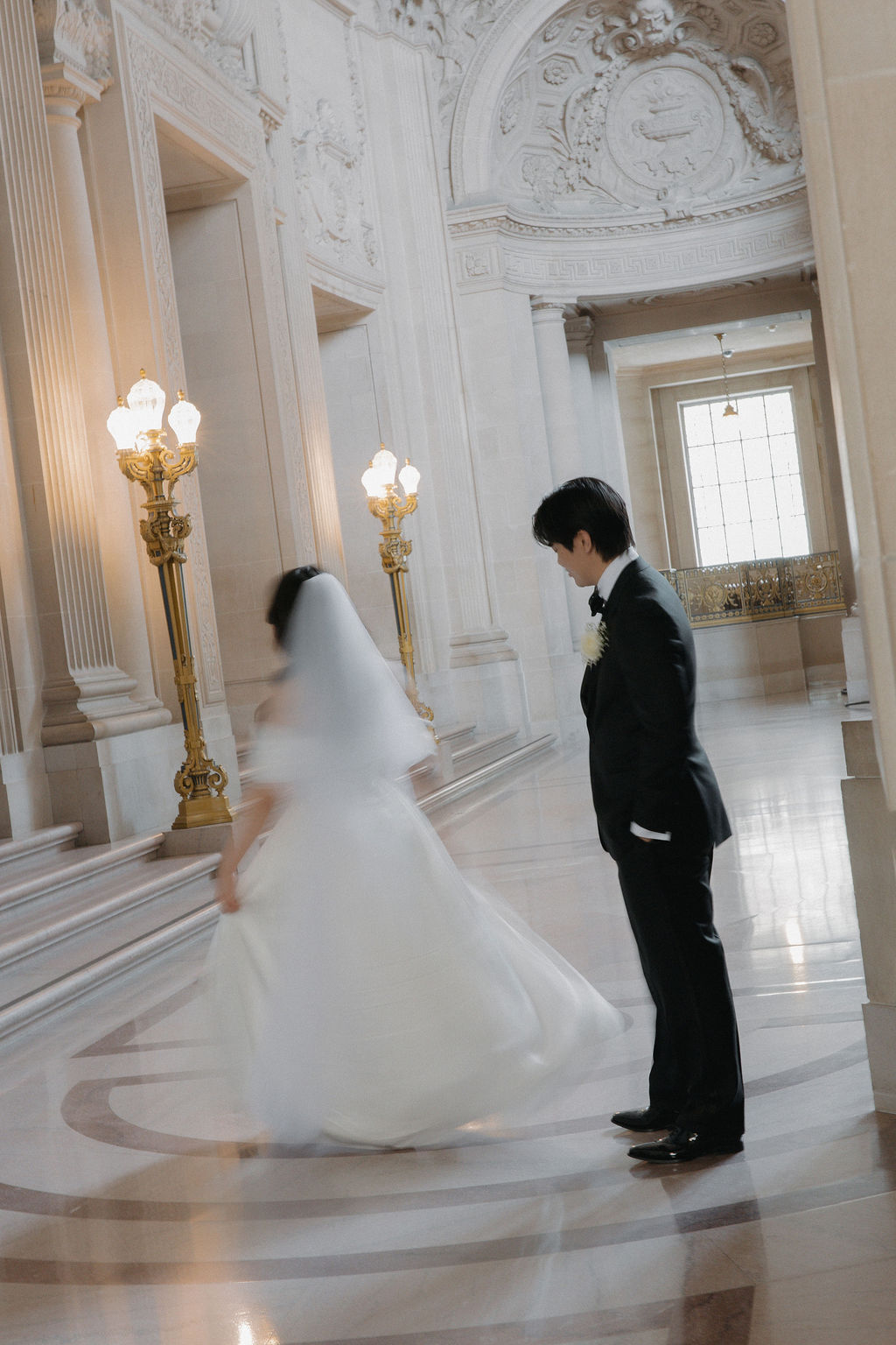A bride spinning while a groom watches her