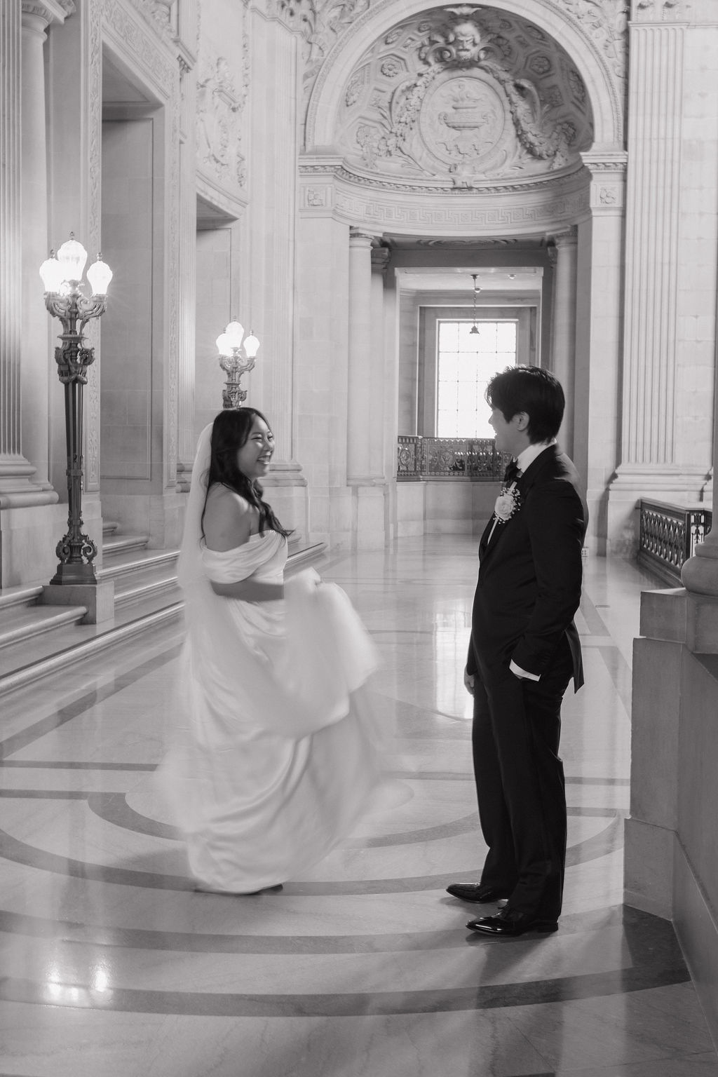 A bride and groom taking wedding photos in SF city hall