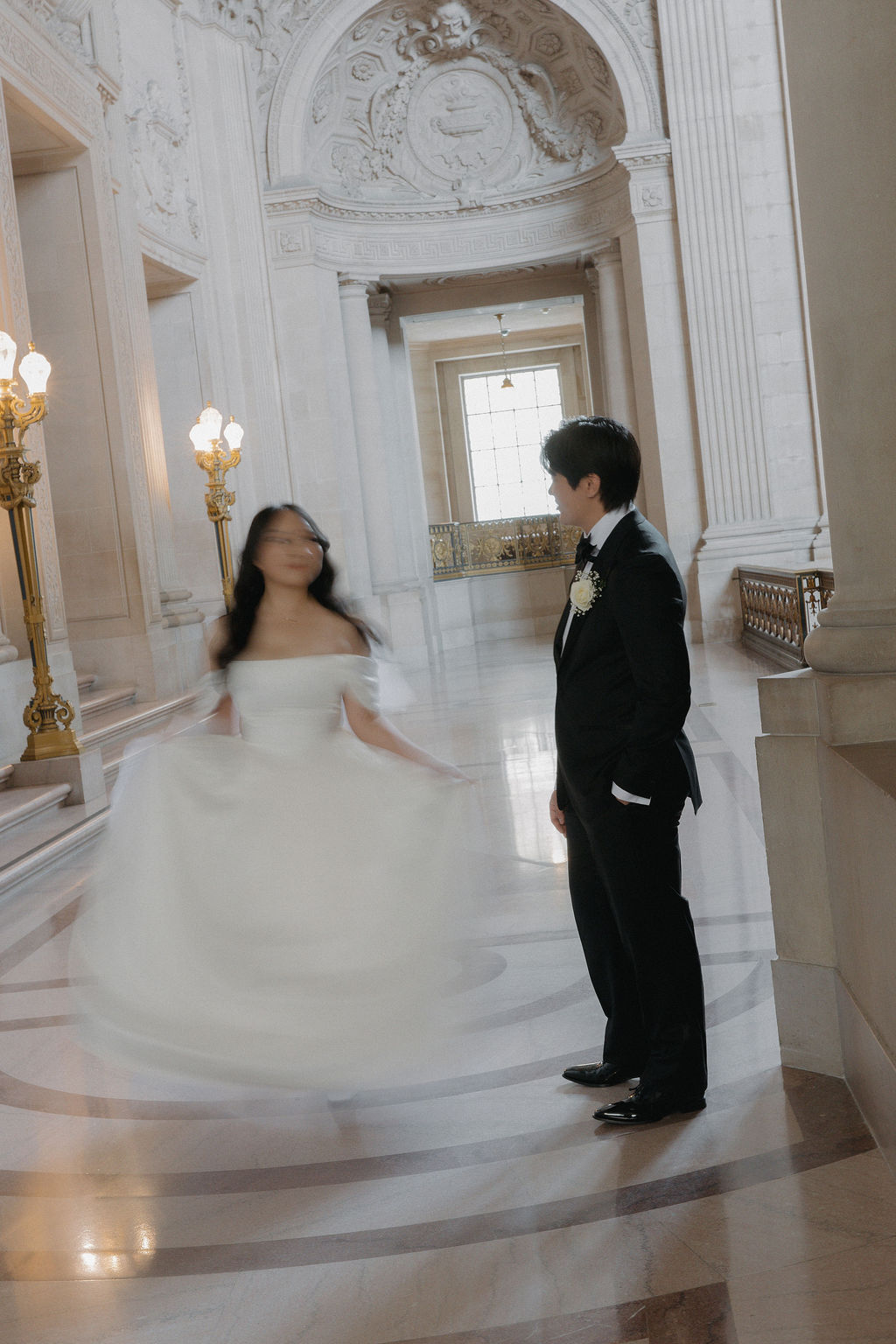 A bride spinning while a groom watches her
