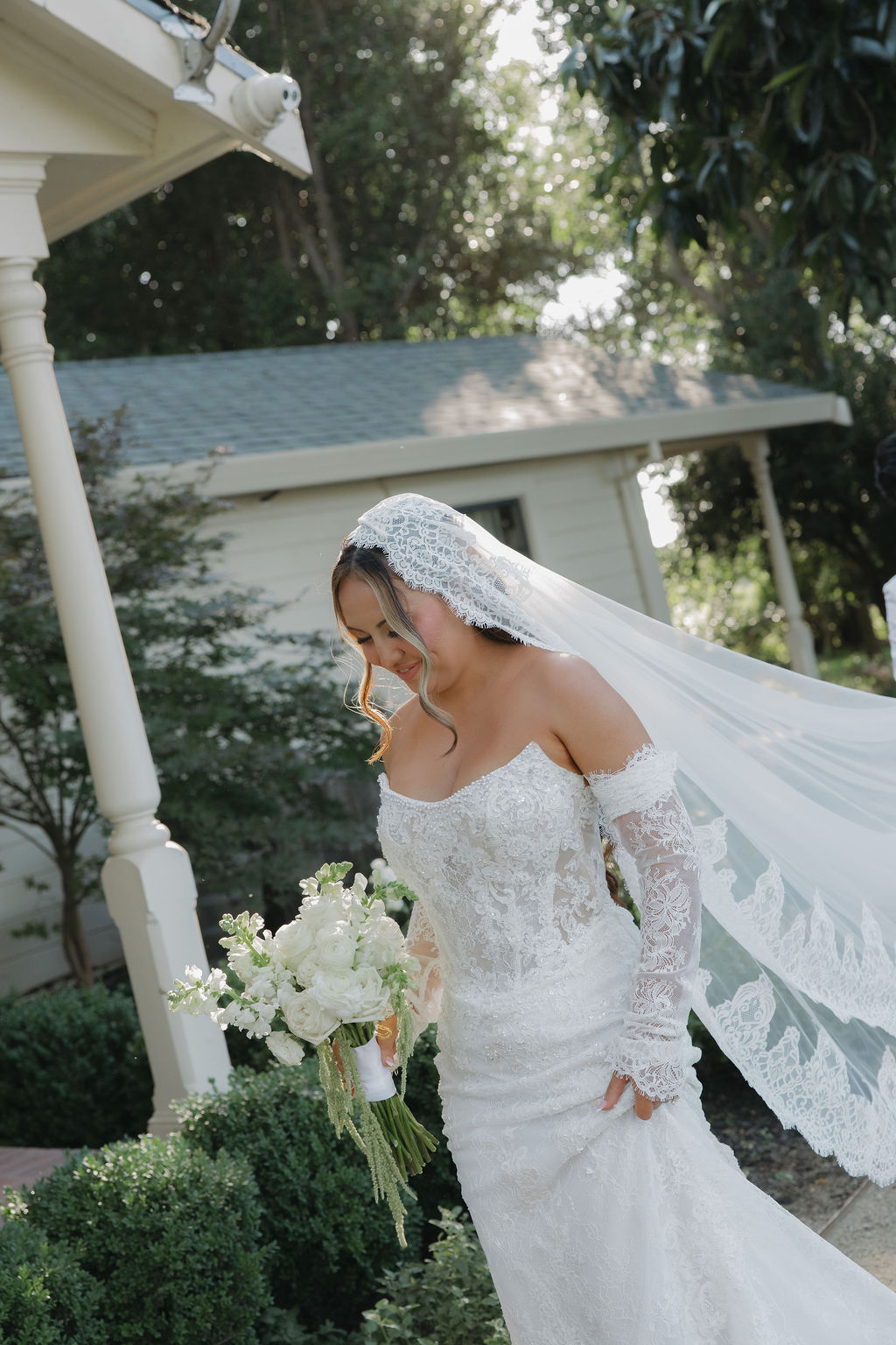A bride in a fitted lace wedding dress
