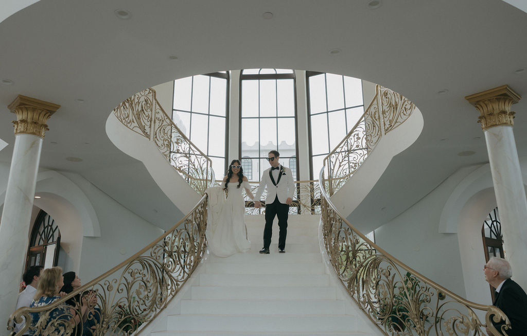 A bride and groom entering their wedding reception 