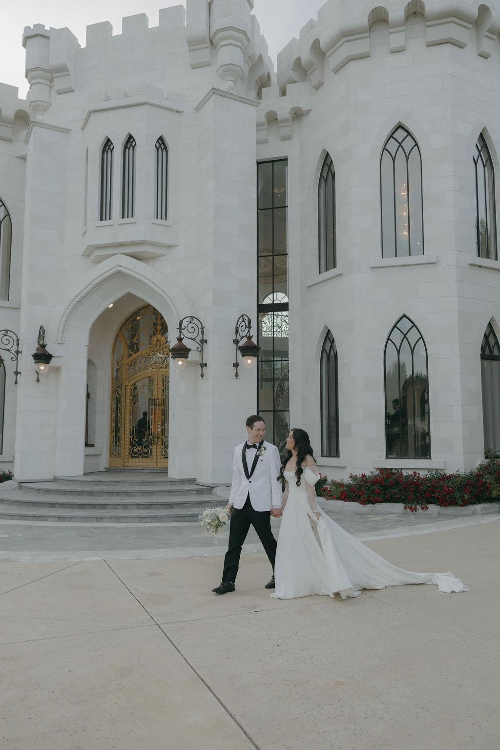 A bride and groom walking across White Swan Castle
