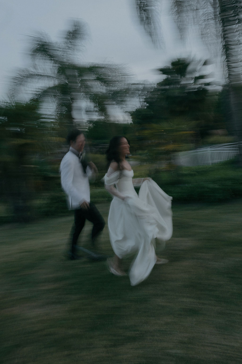 Blurry wedding photos of a couple running