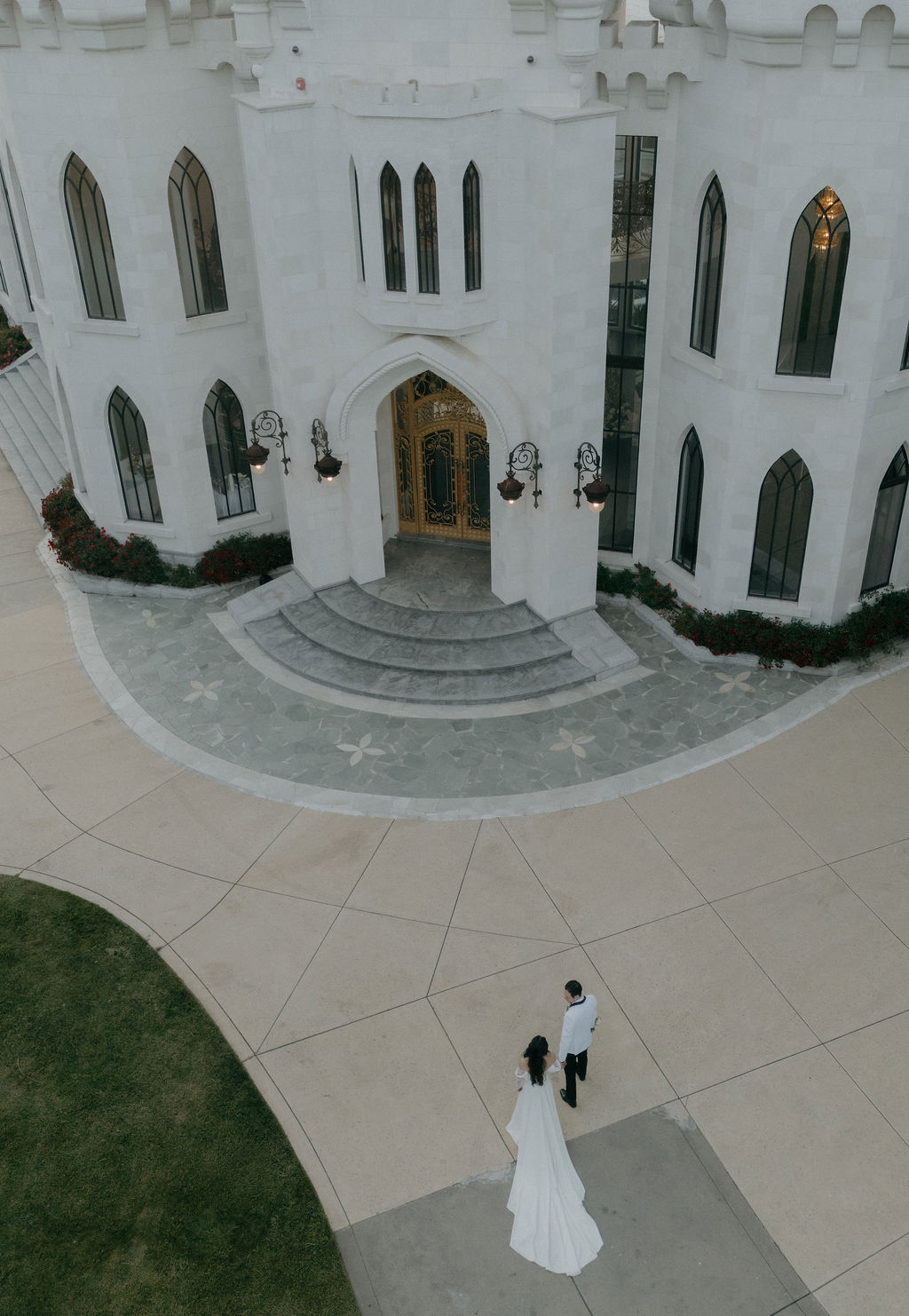 A bride and groom walking together at their wedding venue, White Swan Castle