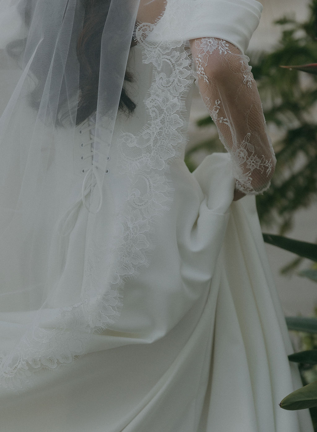 A bride walking in her simple lace wedding dress