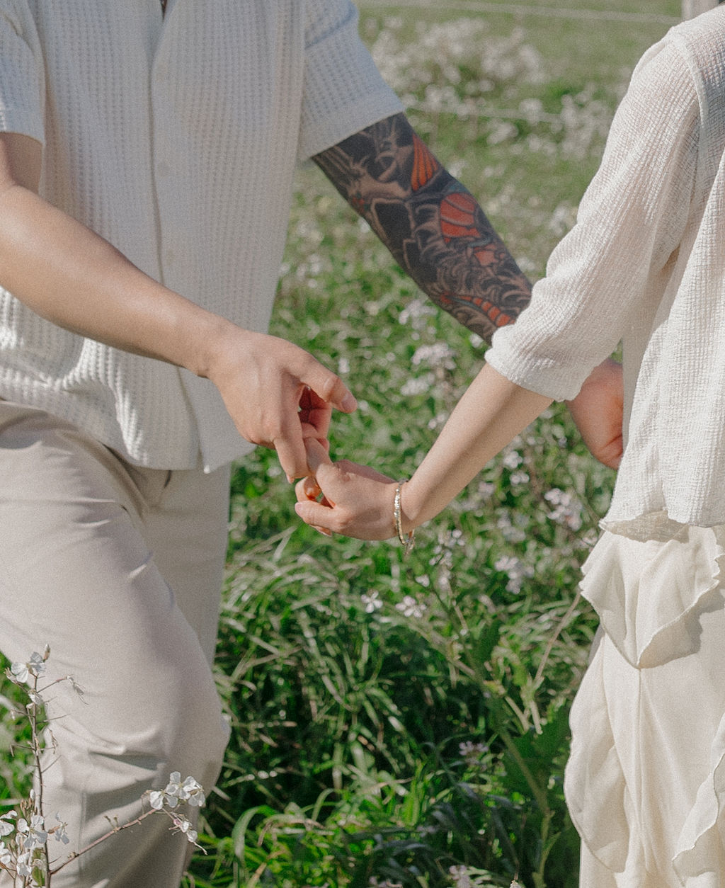 A couple holding hands during spring engagement photos
