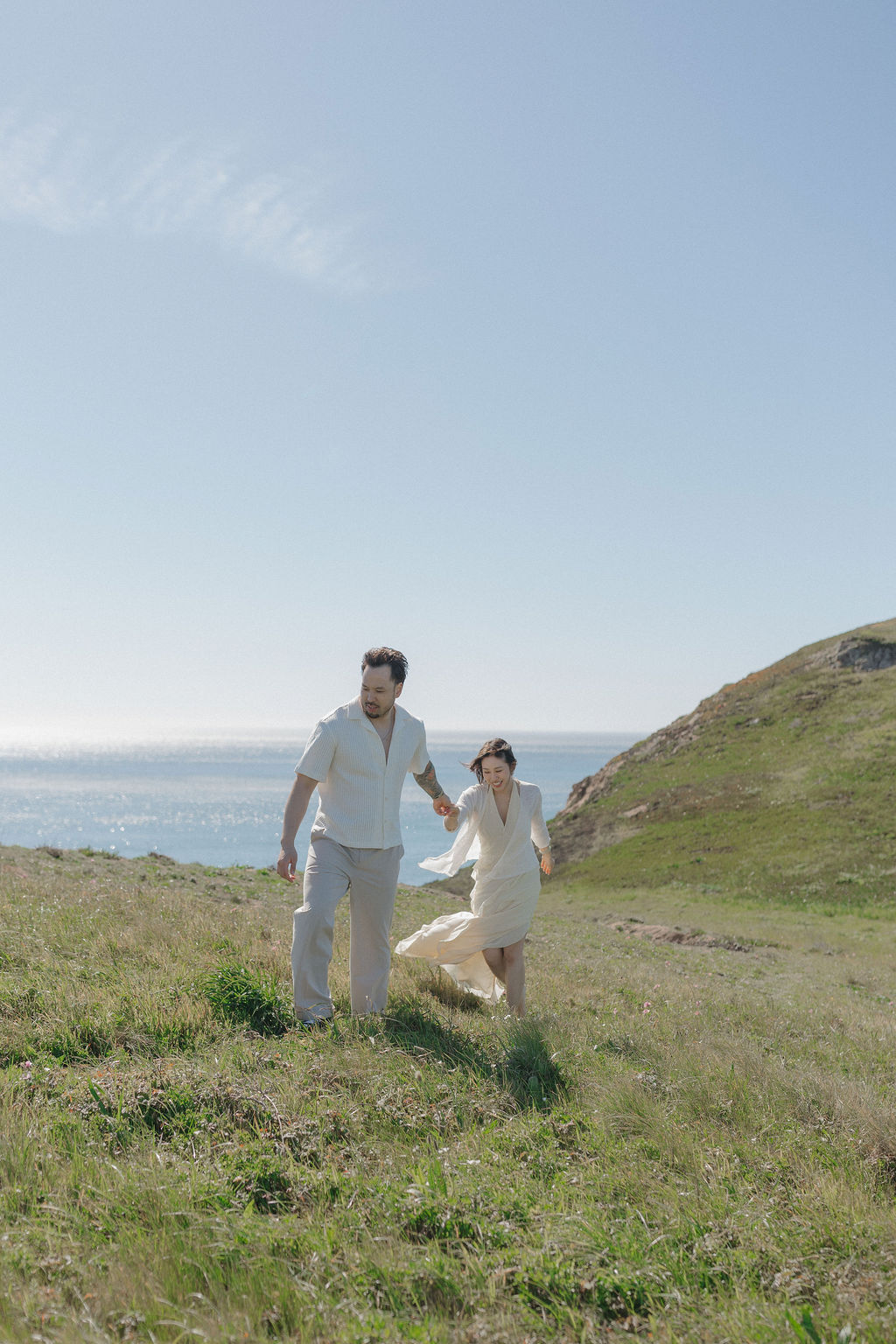 A couple taking spring engagement photos on a cliff