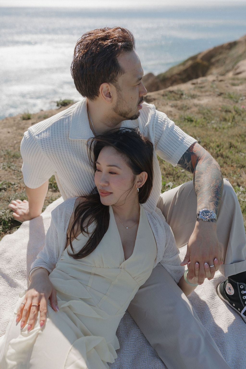 A couple posing for a spring picnic engagement photoshoot