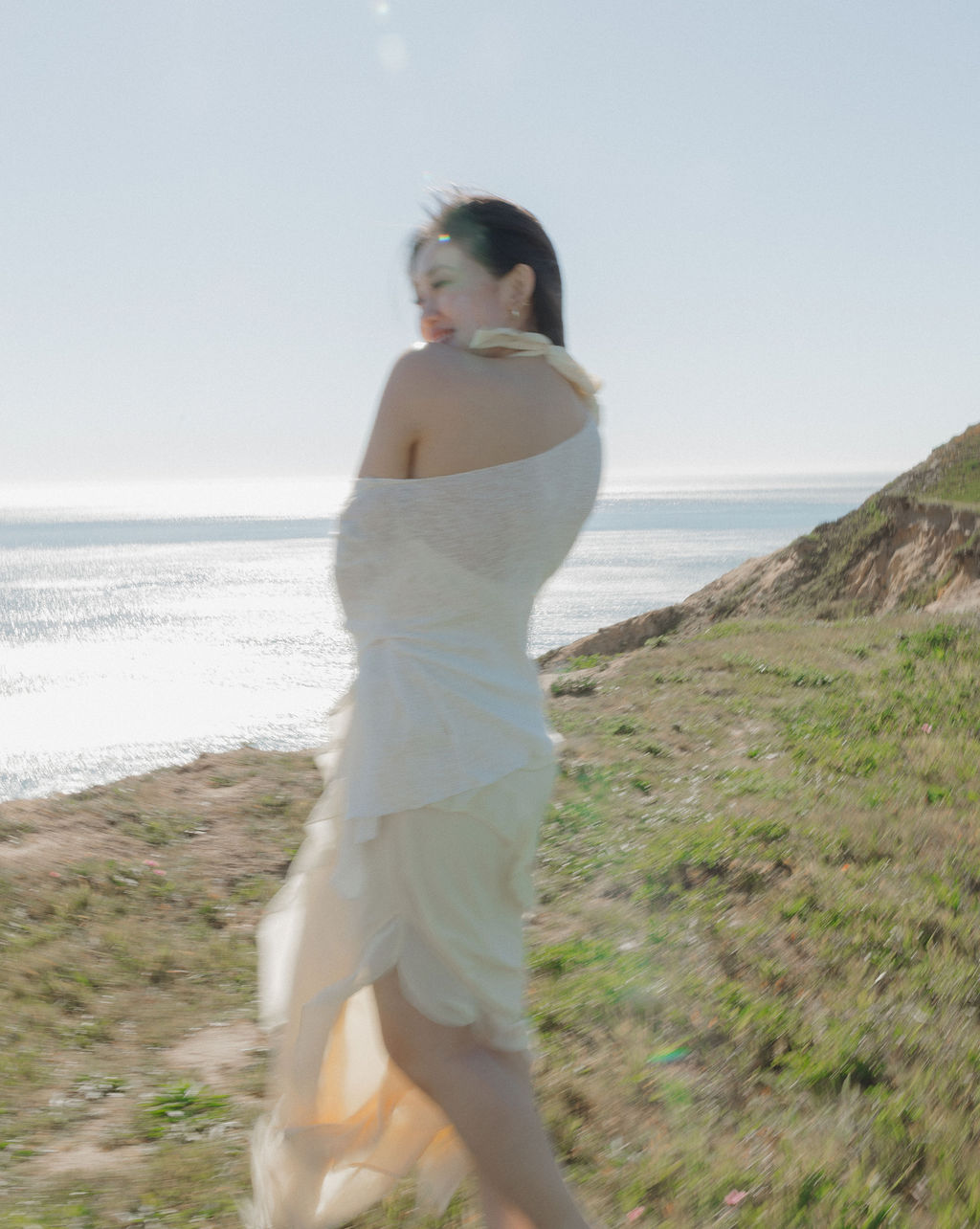 A woman wearing a butter yellow engagement photo dress for spring engagement photos