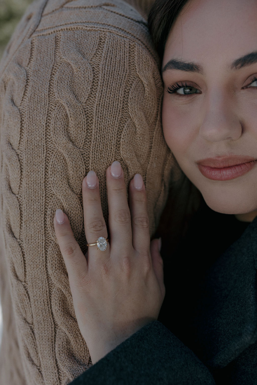A couple hugging during winter engagement photos