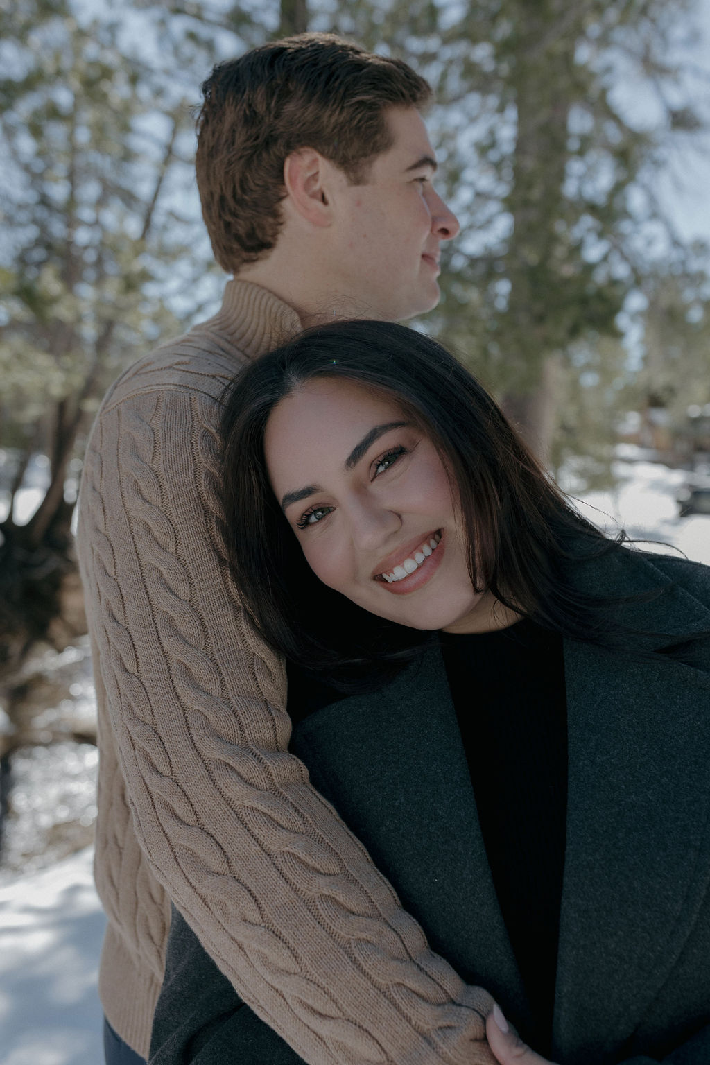 A couple hugging during winter engagement photos
