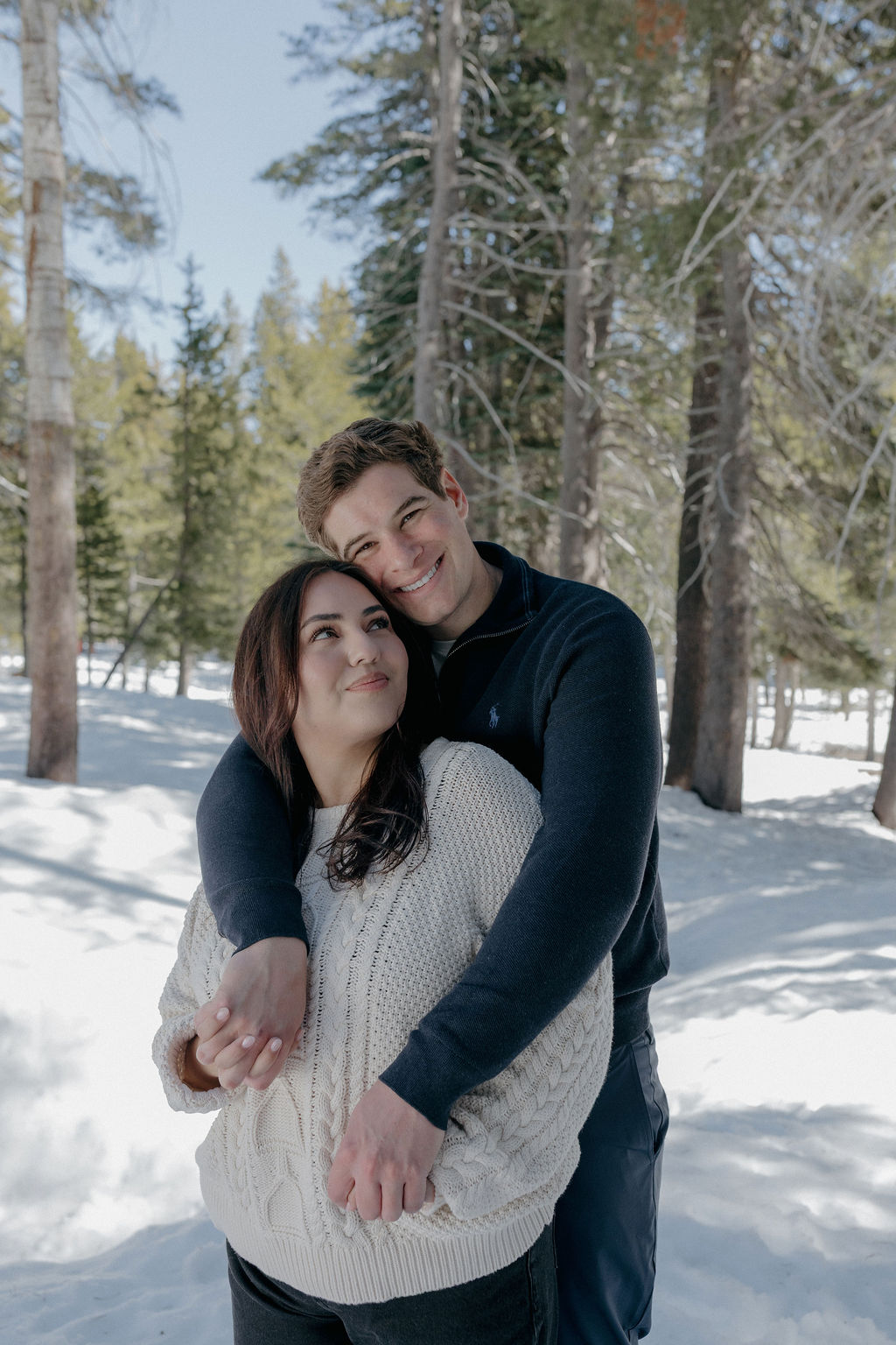 A couple hugging during winter engagement photos