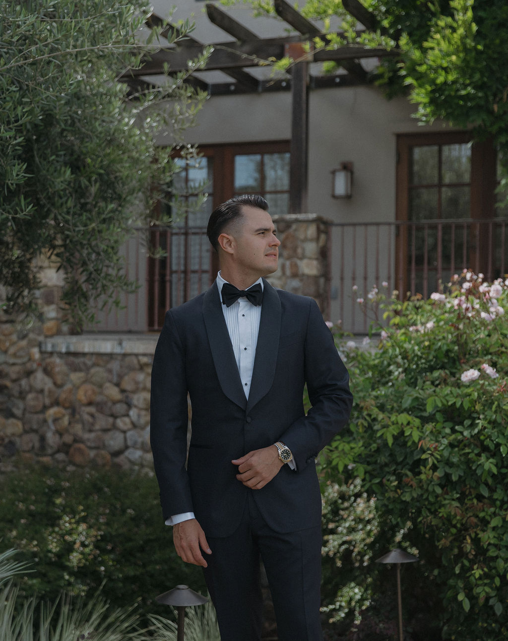 A groom posing for wedding portraits