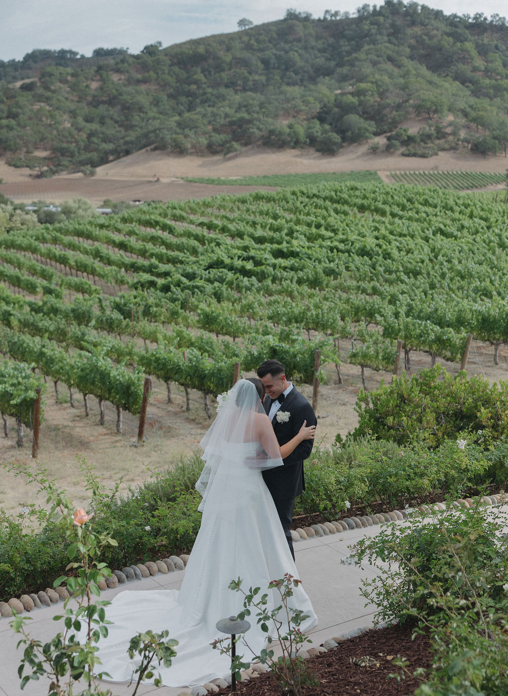 A bride and groom poisng for wedding photos