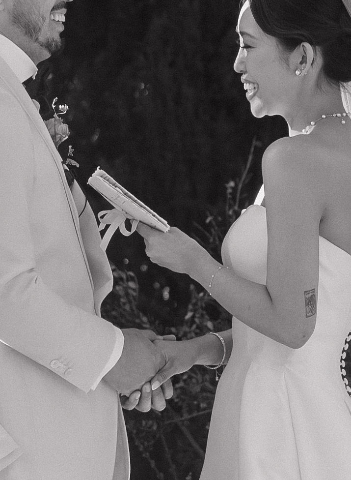 A black and white photo of a bride and groom smiling