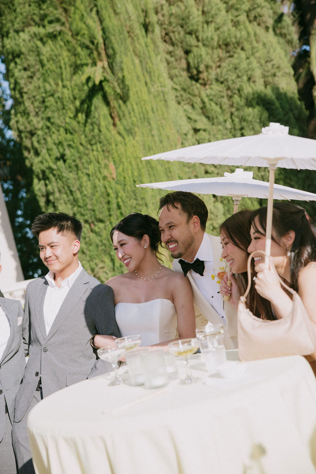 A bride and groom taking photos with wedding guests