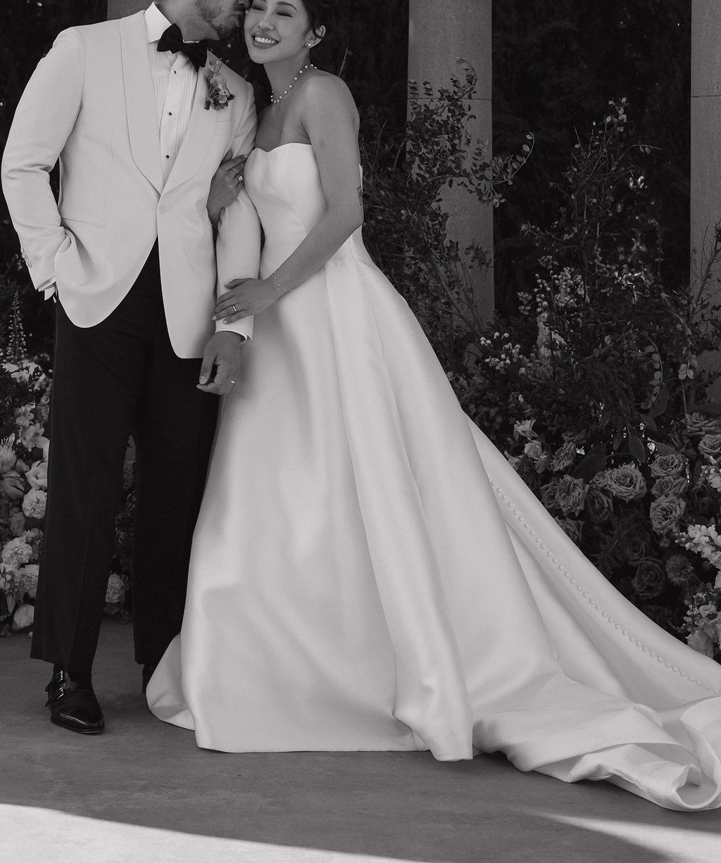 A black and white photo of a bride and groom smiling