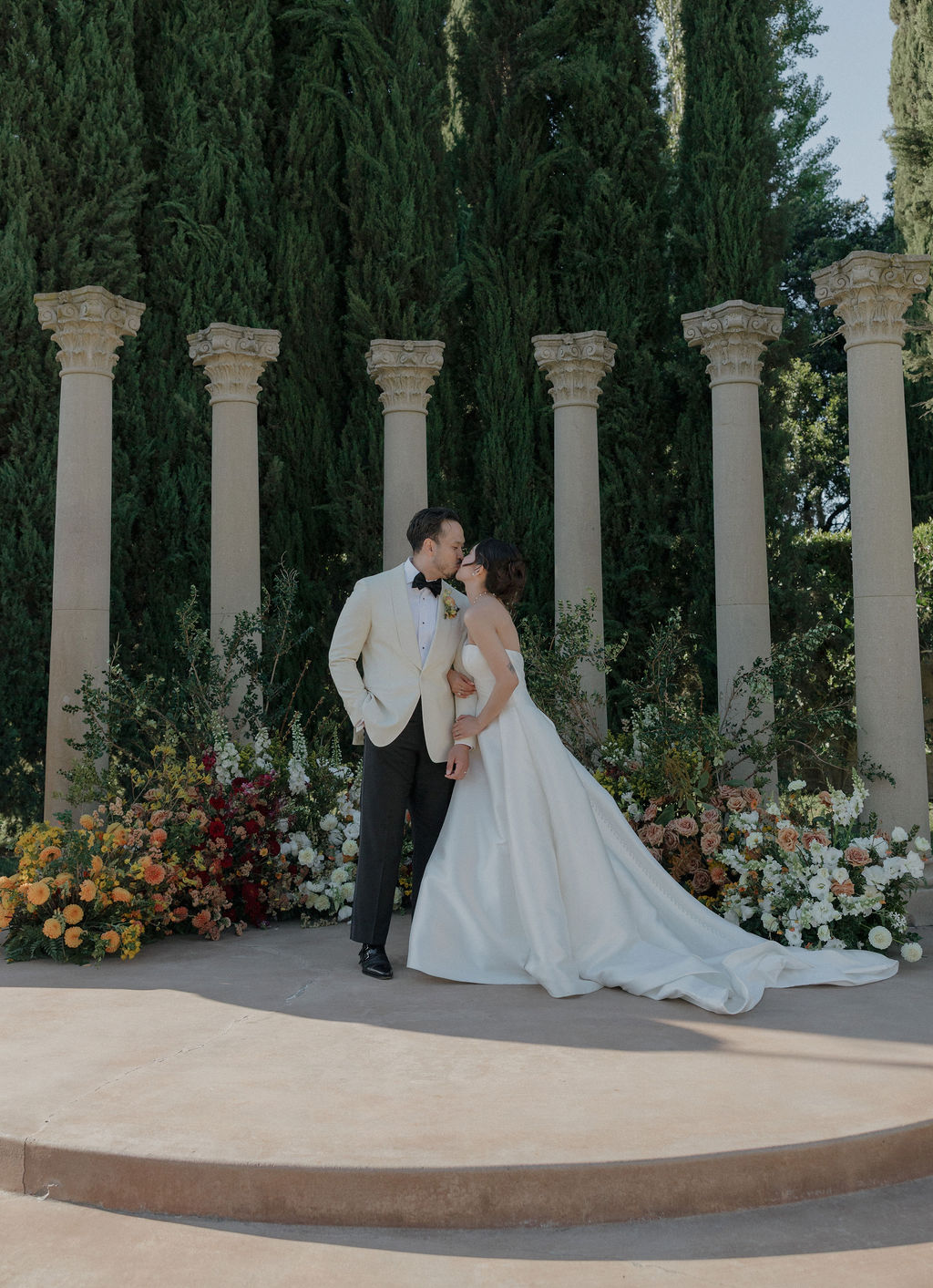 A bride and groom posing in front of fall wedding ideas
