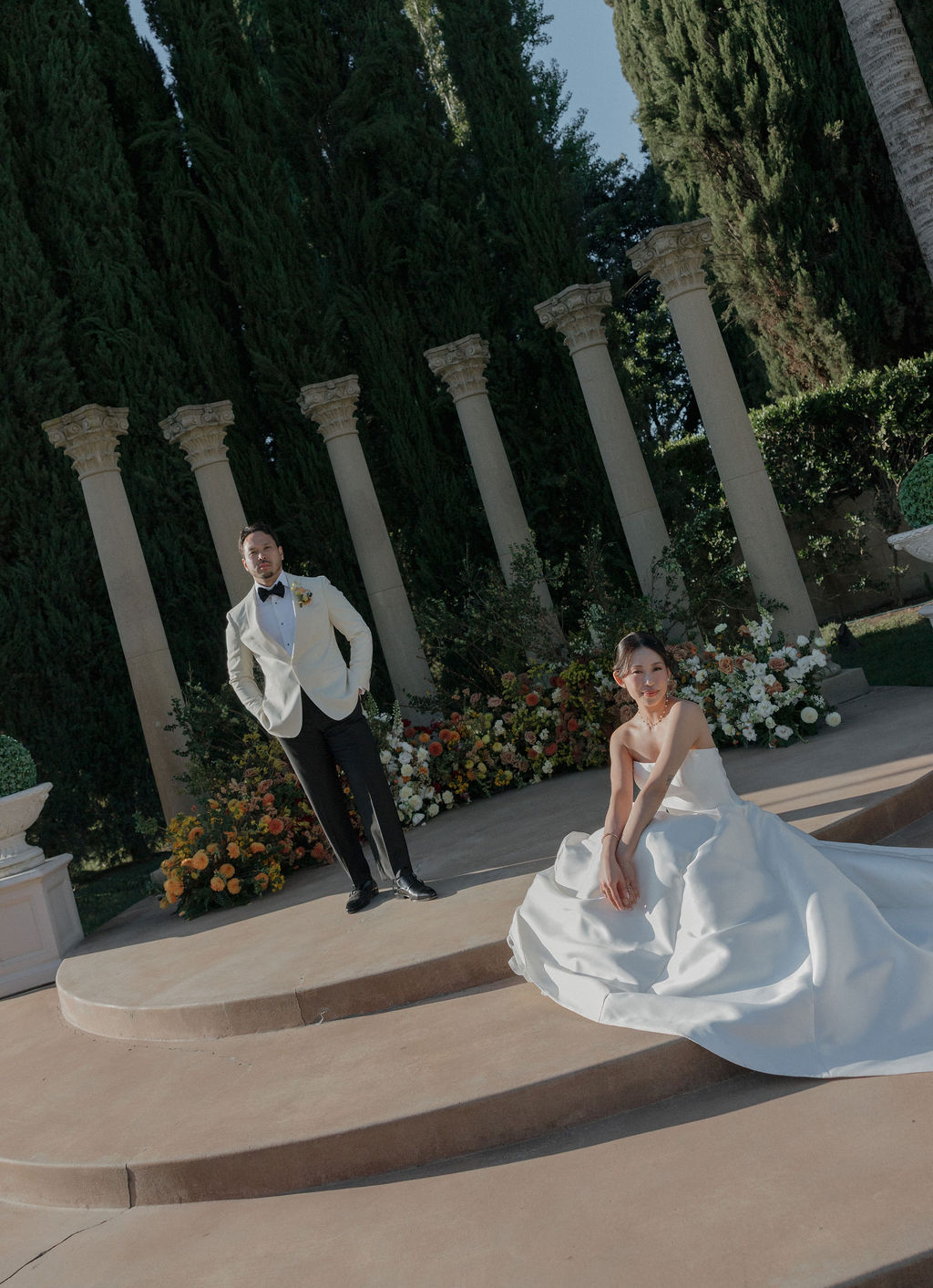 A bride and groom posing in front of fall wedding ideas