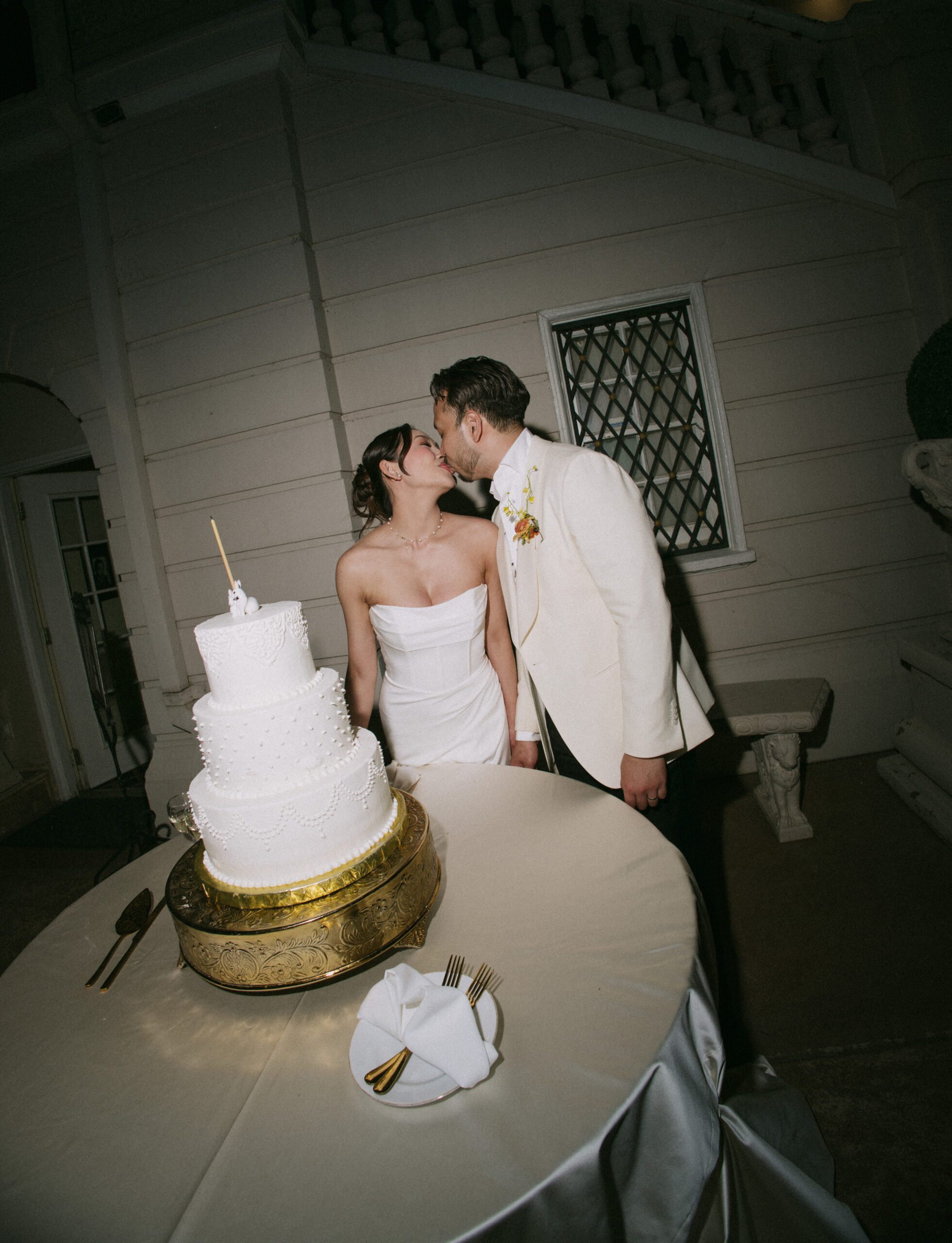 A bride and groom doing their wedding cake cutting