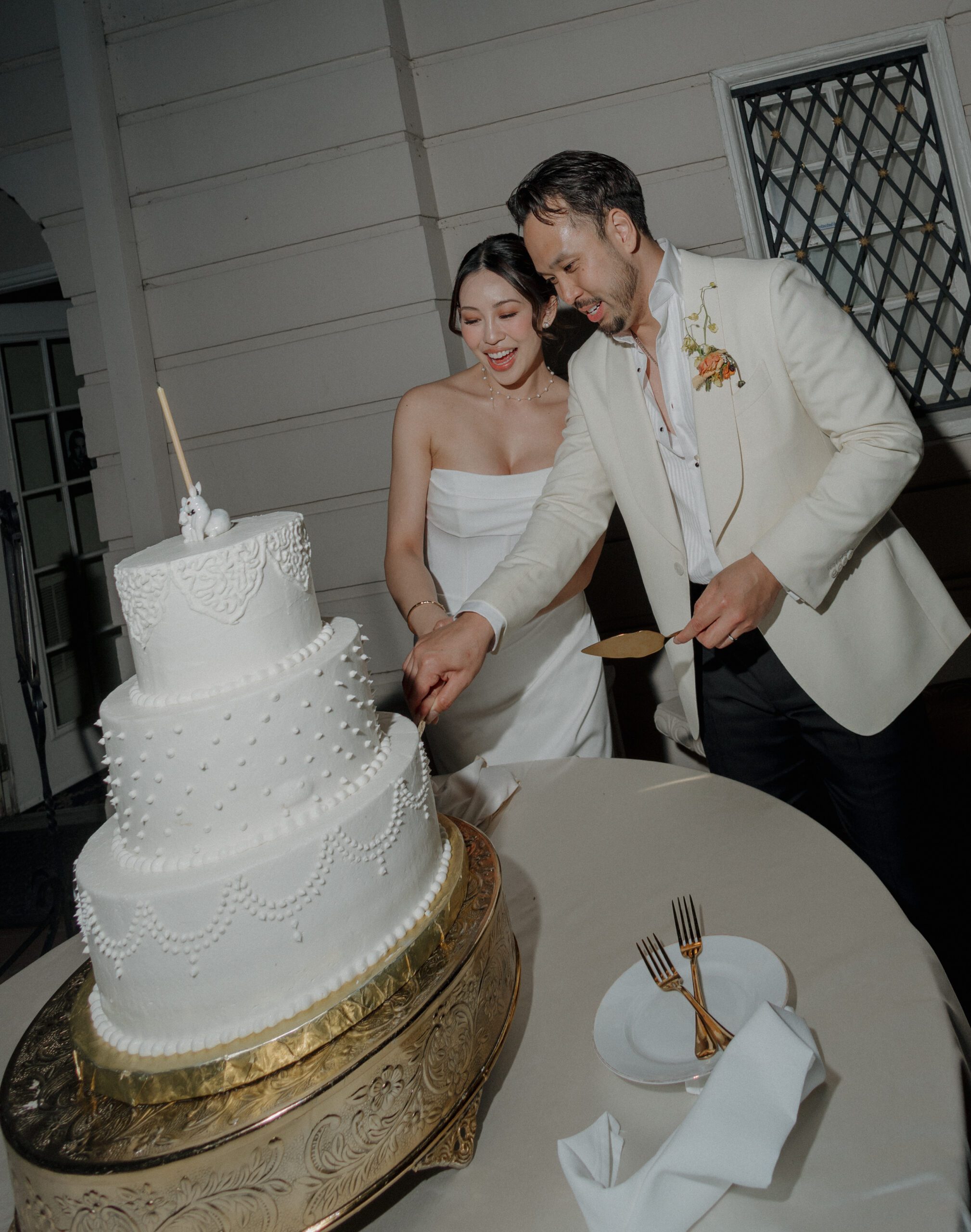 A bride and groom doing their wedding cake cutting