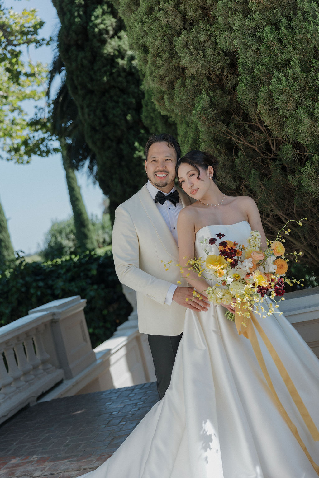 A bride and groom posing for wedding portraits