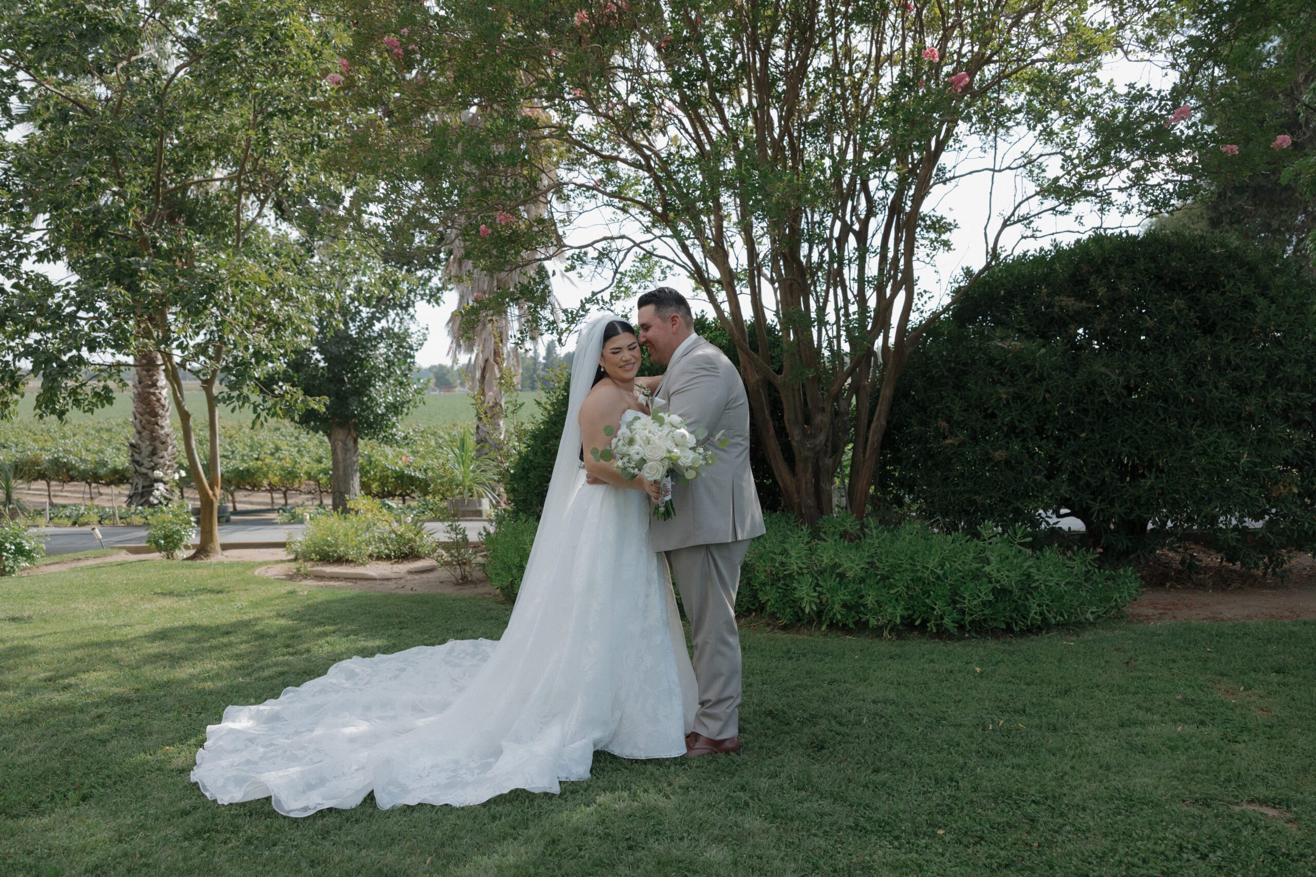 A bride and groom posing for photos at their winery wedding venue