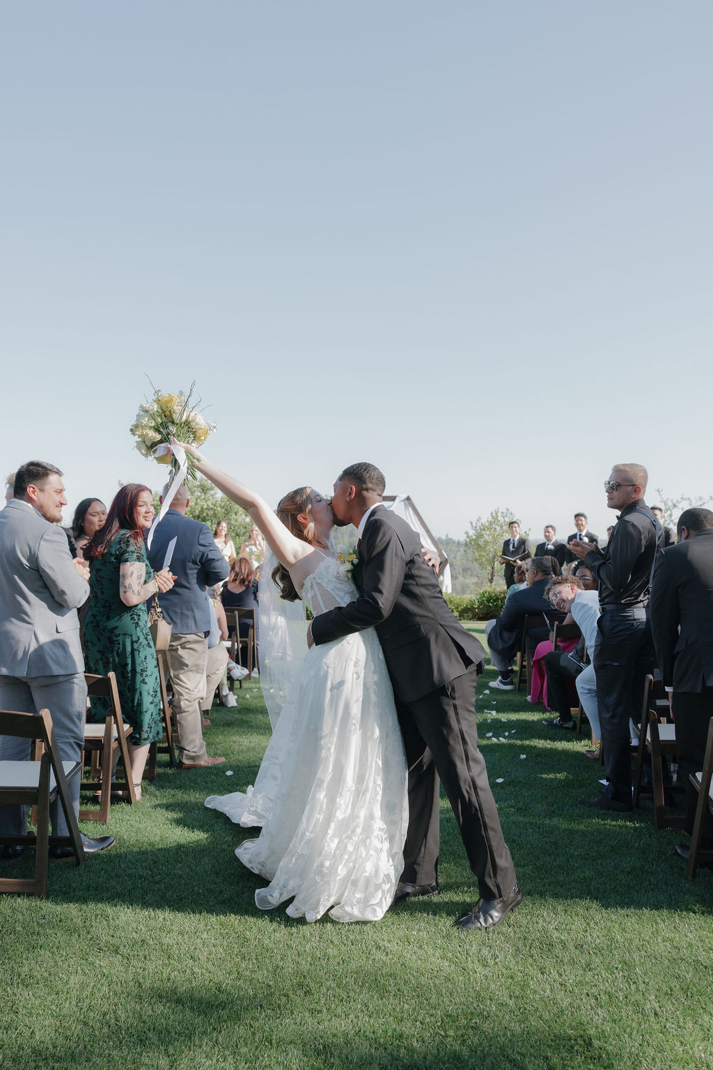 A bride and groom kissing after their wedding ceremony