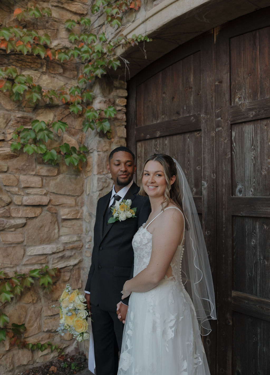 A bride and groom posing for wedding portraits