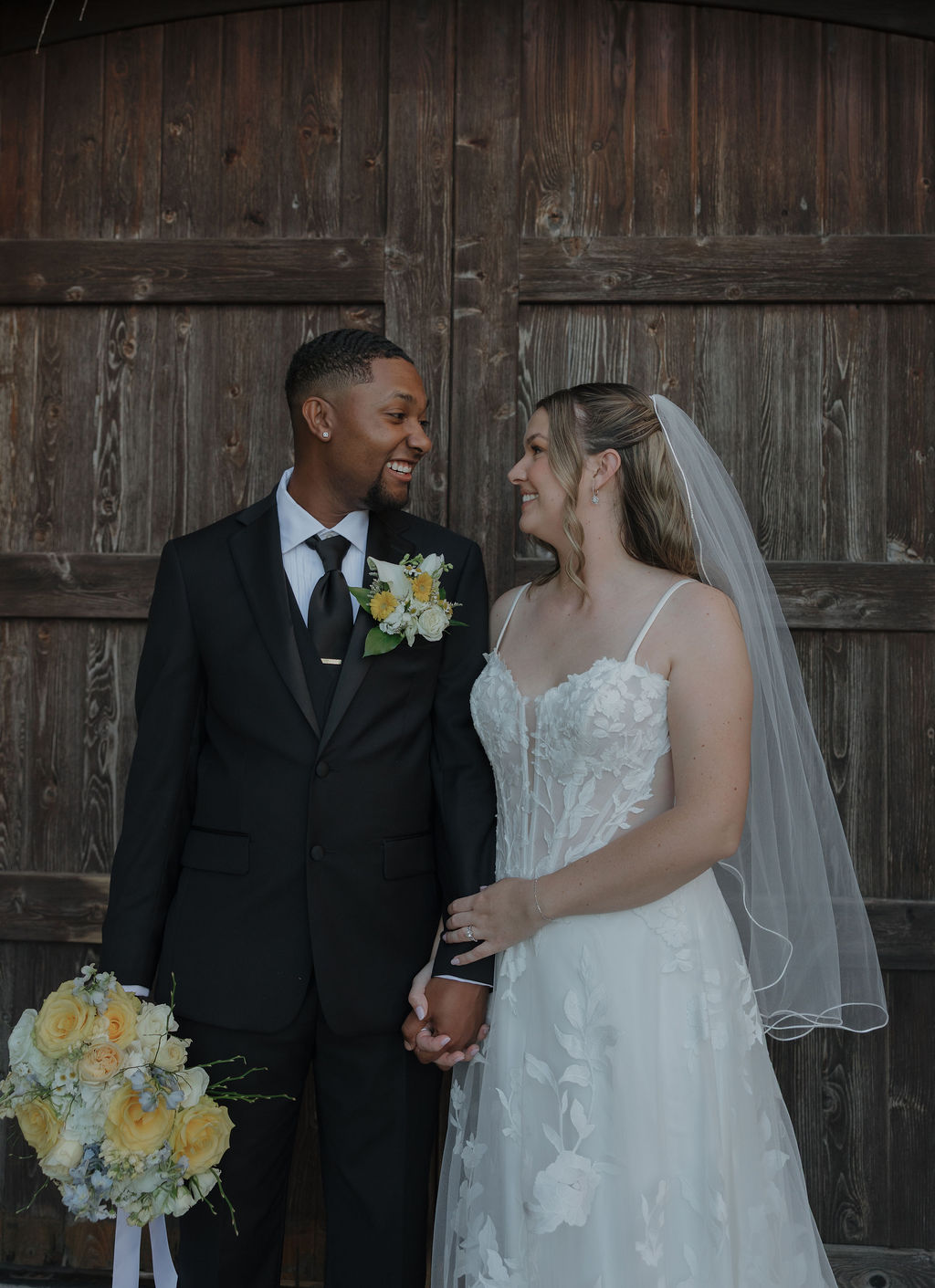 A bride and groom posing for wedding portraits